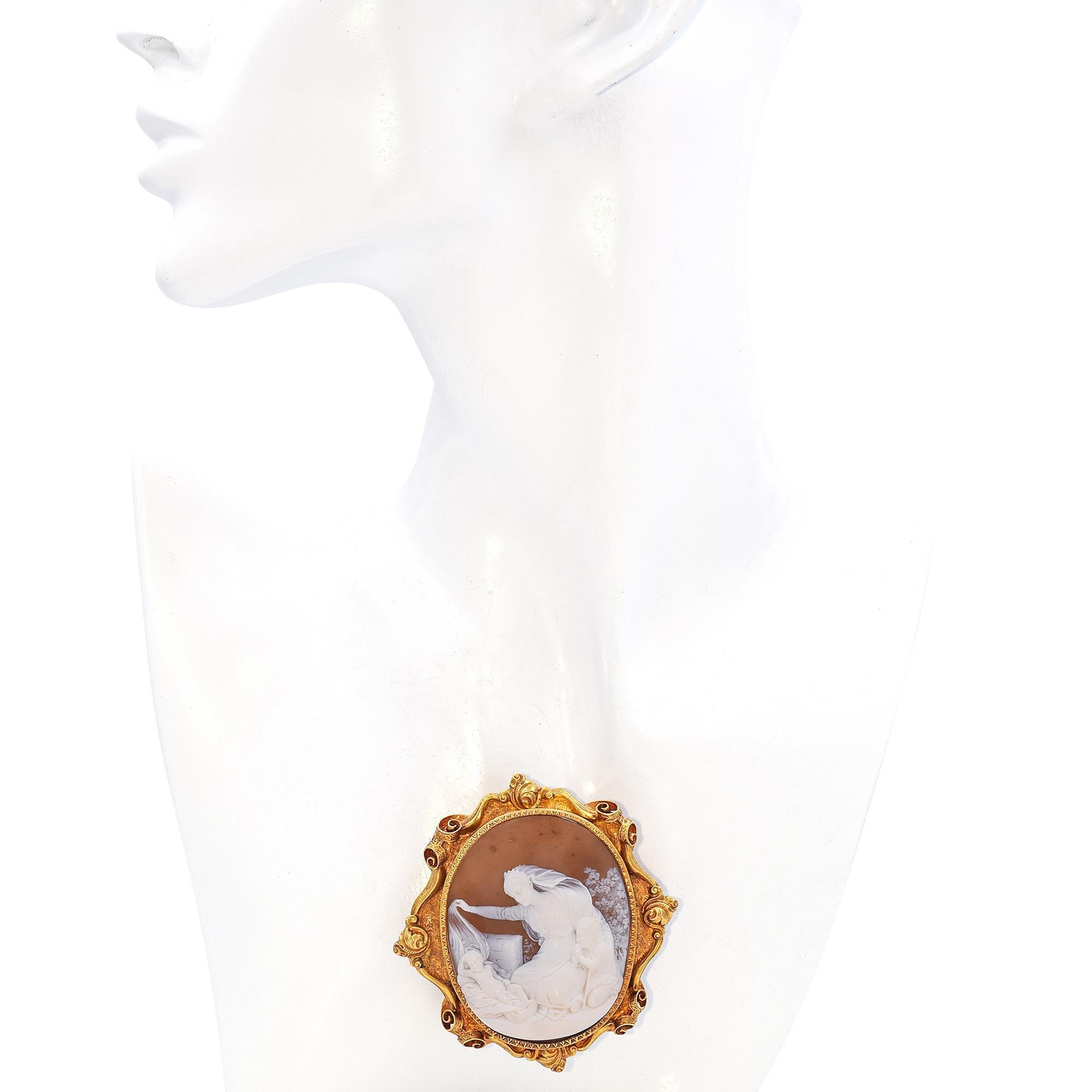 This exquisite pendant brooch features a finely carved sardonyx cameo, intricately detailed to depict Raphael's Angel, inspired by The Sistine Madonna—an oil painting created by Raphael in 1513–14, during the Italian High Renaissance. The cameo is