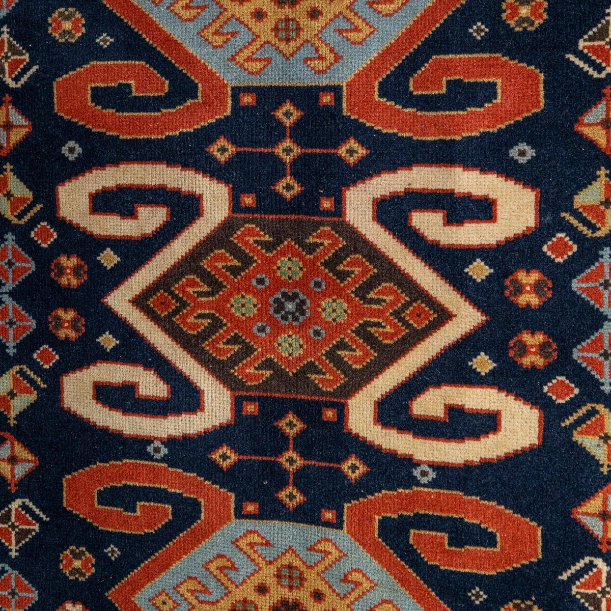 Ancien tapis caucasien du 20e siècle fait à la main. Délicatement tissé avec cinq motifs centraux et une bordure attrayante, ce tapis présente une palette de couleurs saisissantes. Les tapis persans du Caucase sont connus pour leurs motifs