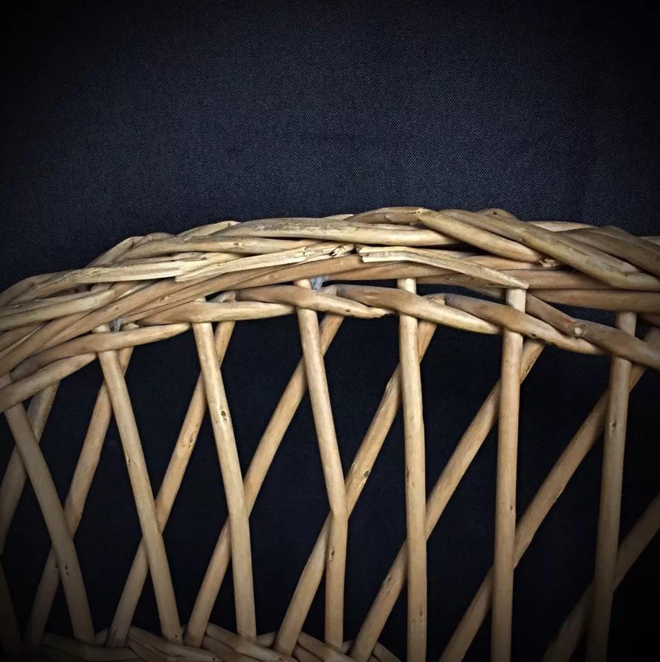 This charming antique children's chair, crafted from wood and wicker, dates back to the early 20th century. A beautifully aged piece, it exhibits the rustic wear of its time, making it a unique addition to any vintage collection or nursery