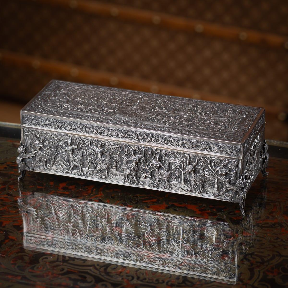 Antique 20th Century Chinese export solid silver box, made for Thai market. The box is fully repoussé-decorated in high relief scenes from Burmese mythology, specifically the Pandara Jataka. The box is mounted on four raised feet and the underneath