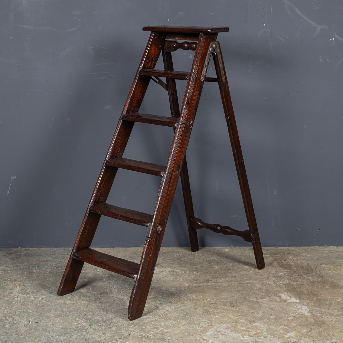 Antique 20th Century Edwardian wooden ladders. Made in England around 1910, these ladder feature a metal latch that pushes down to lock in the ladder making it safe and sturdy to use, hence the name 