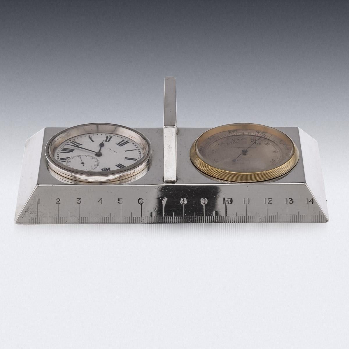 20th century English silver desk clock, ruler and thermometer. In fully working order, the clock with a white face and roman numerals, with a hand winder on reverse. Thermometer made by J.C.Vickery, London, comes in a solid silver carrying case and