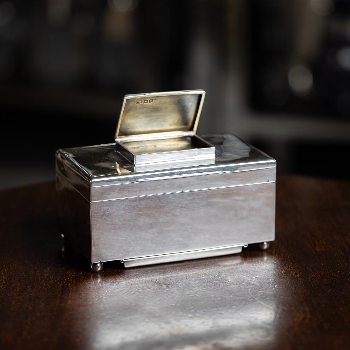 Antique early 20th Century English solid silver four tier cigar box. A refined silver four-tier box designed for smoking essentials—matches in the top tier, followed by compartments for cigarettes and cigars, with a concealed ashtray in the base.