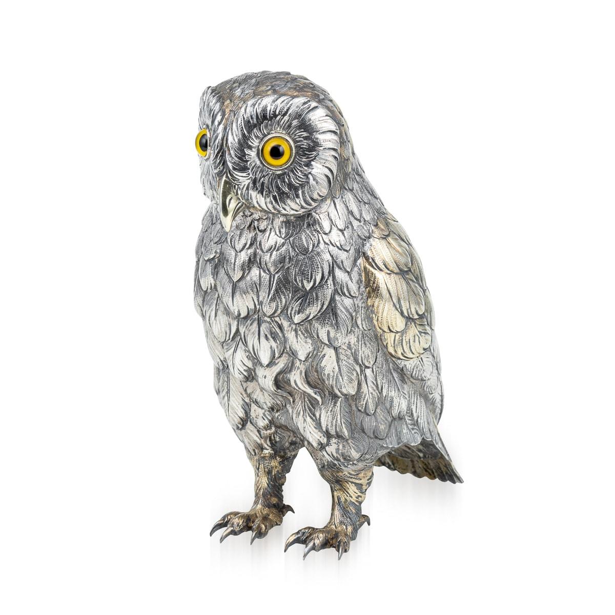 Antique 20th Century German solid silver figure of an owl. This realistically modelled bird has original set glass eyes and gilt feathers plumage. A true conversation piece, that will add novelty and fun to any household setting. Hallmarked German