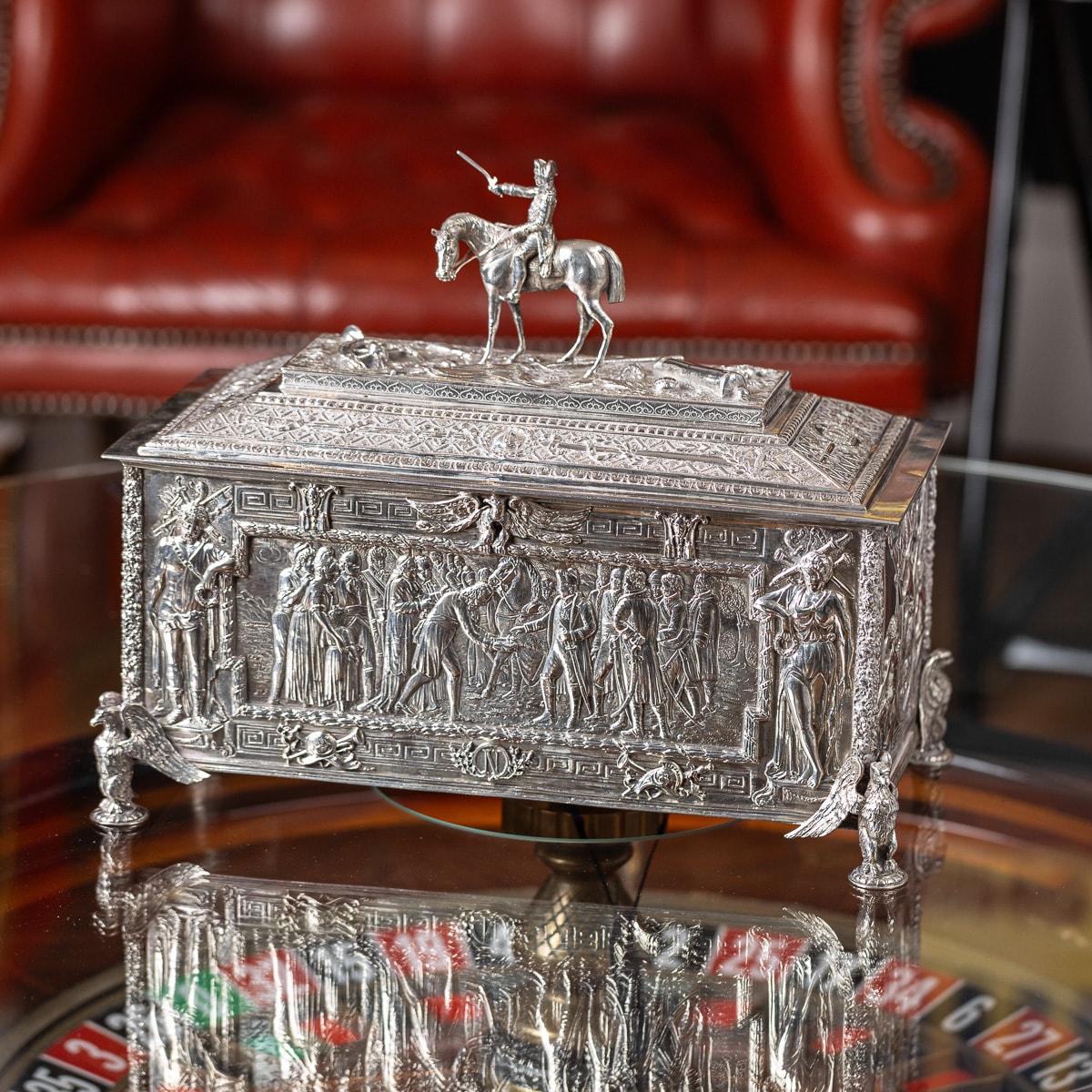 Antique early 20th Century German solid silver casket, decorated with scenes known as 'The Triumph of Napoleon'. This rectangular sarcophagus-shaped piece features intricate scenes on its panels: the front depicts Napoleon receiving the key to the