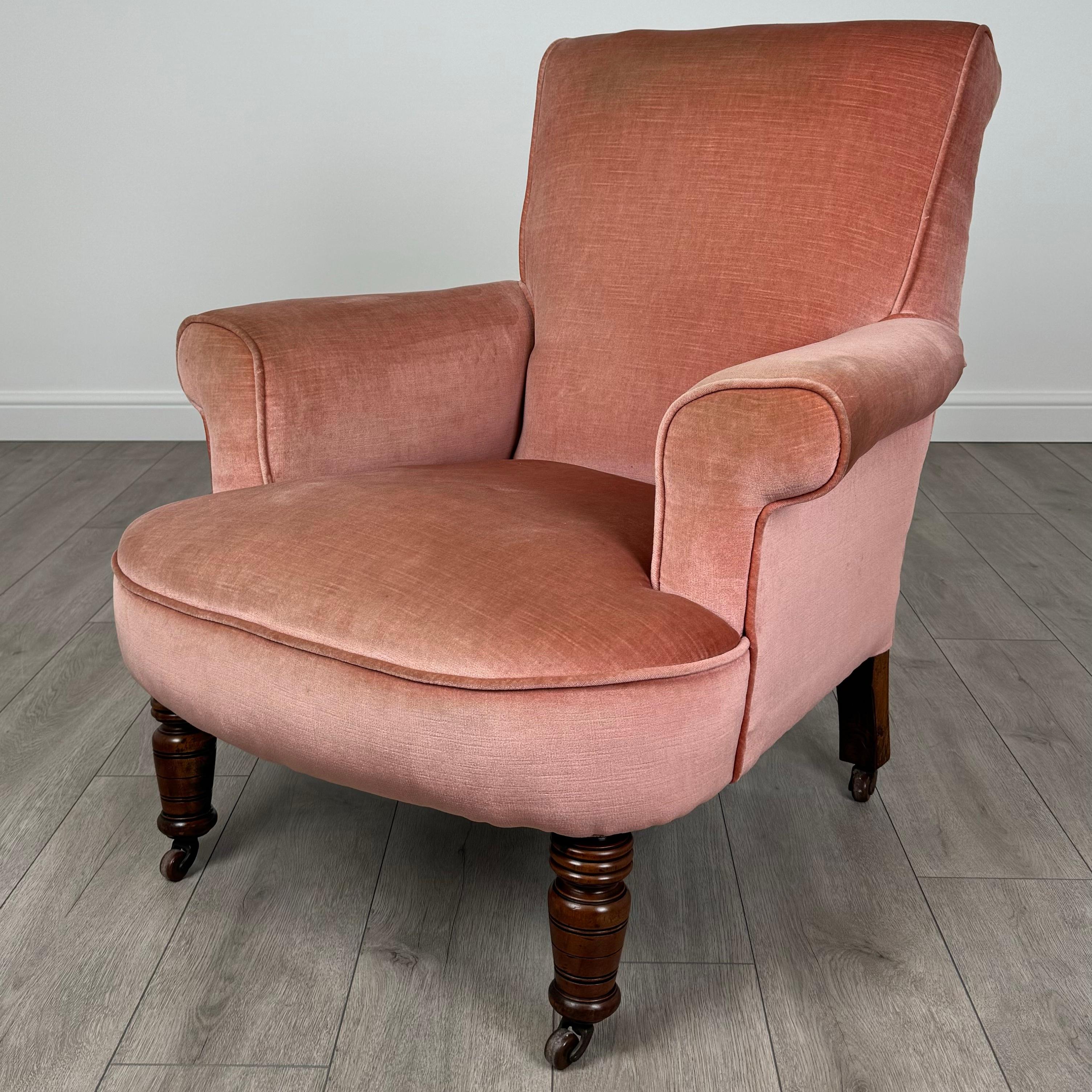 Cet élégant fauteuil ancien du XXe siècle est fabriqué en acajou fin, présentant un grain étonnant et une couleur riche sur l'ensemble des pieds et de la structure. La chaise repose sur des pieds tournés munis de roulettes, offrant à la fois style