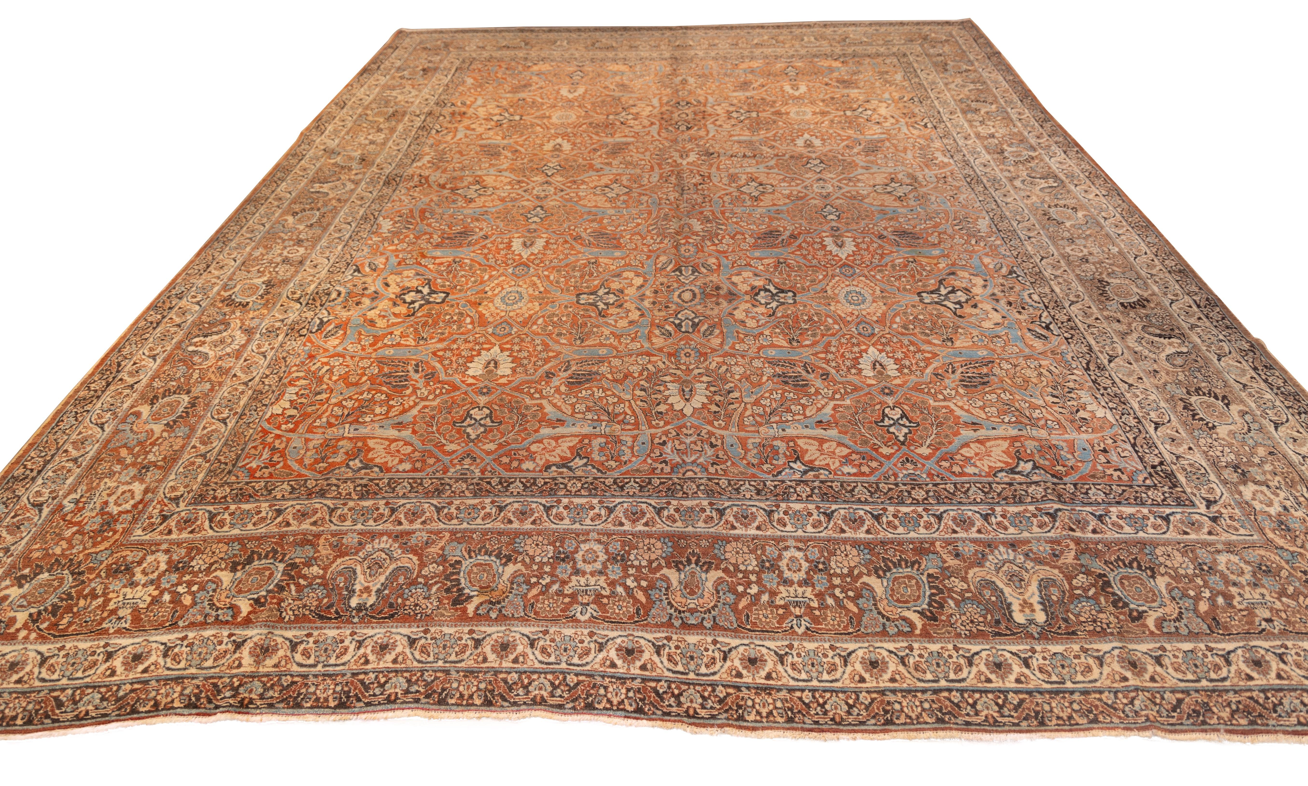 Exquisite Tabriz carpet showcasing  a dense allover herati lattice design rendered in muted coral, ivory, celadon, and soft blues. The field is meticulously filled with stylized palmettes, rosettes, and delicate vinery in a rhythmic repeat.

The