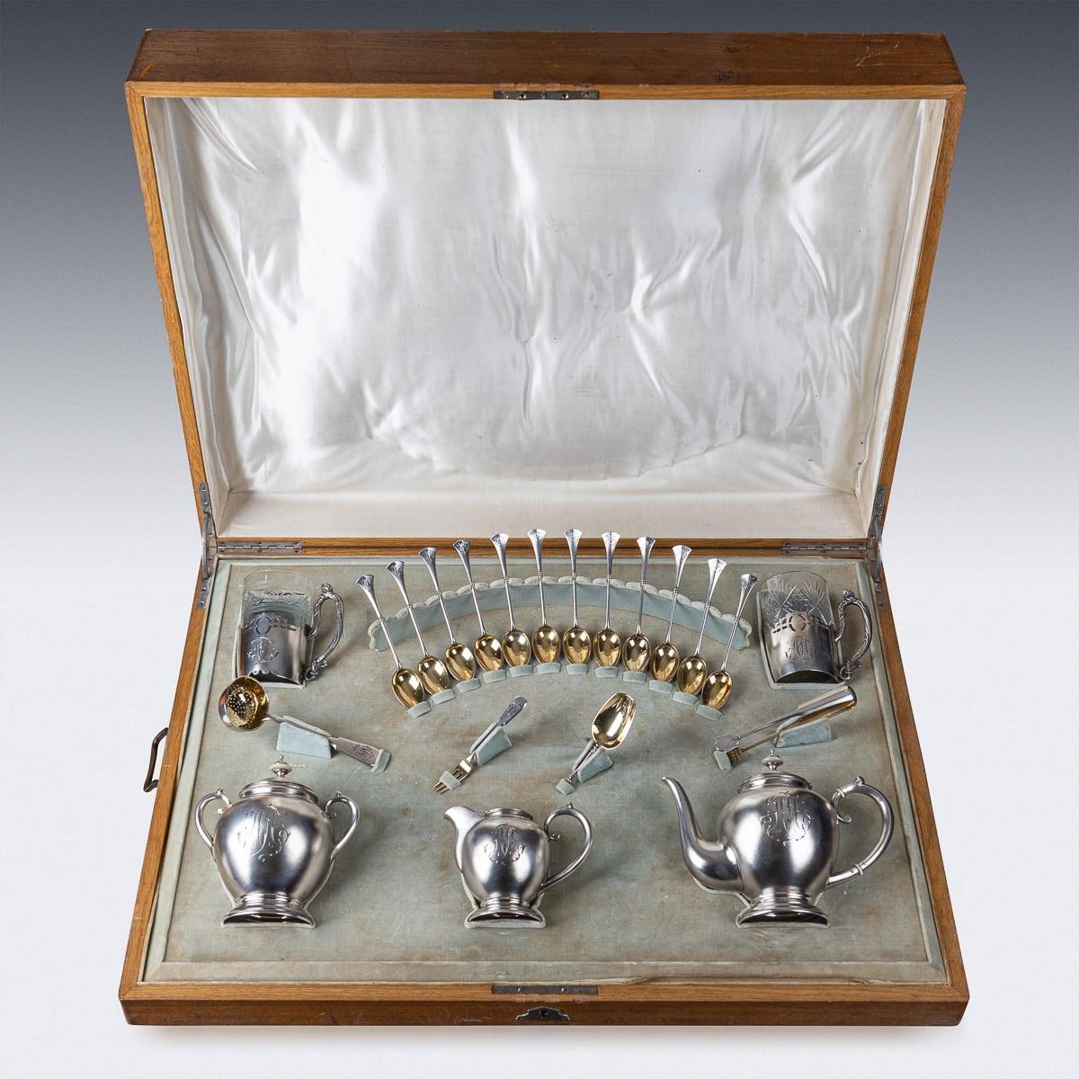 Antique early 20th Century Imperial Russian solid silver tea service, comprising a teapot, sugar bowl, milk jug, two tea glasses with later added removable inserts, a tea strainer, sugar tongs, spoon, fork, and twelve teaspoons, all housed in a