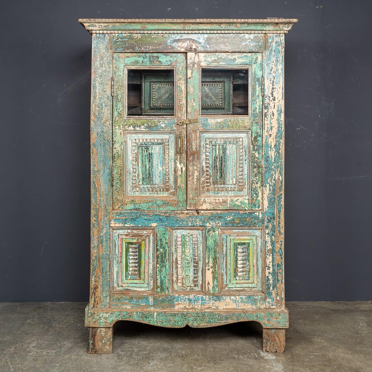 Antiguo armario indio del siglo XX de madera maciza con dos puertas frontales y un cajón con estante interior. La verdadera belleza de esta pieza reside en la rica pátina del exterior pintado, desarrollada a lo largo del tiempo. Un complemento