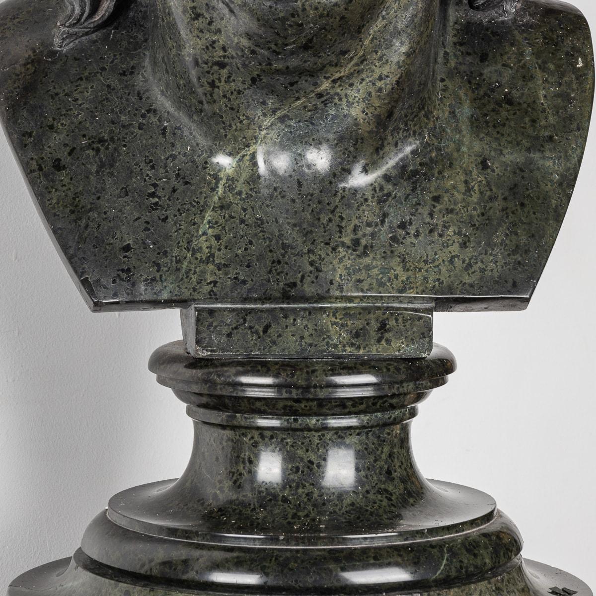 Crafted in the 20th Century, this Antique Italian green marble sculpture depicts the bust of a sorrowful young man gazing to his right. Resting upon a two-part pedestal crafted from Italian marble, this exquisite masterpiece radiates grace and