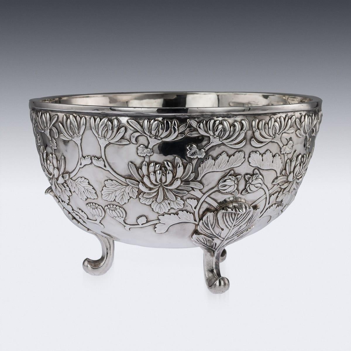 Antique early 20th century Japanese Meiji period monumental solid silver bowl, exceptional and magnificent quality, double walled on three scroll leaf feet, embossed with chrysanthemums. The base is marked with jin-jung mark, meaning pure silver