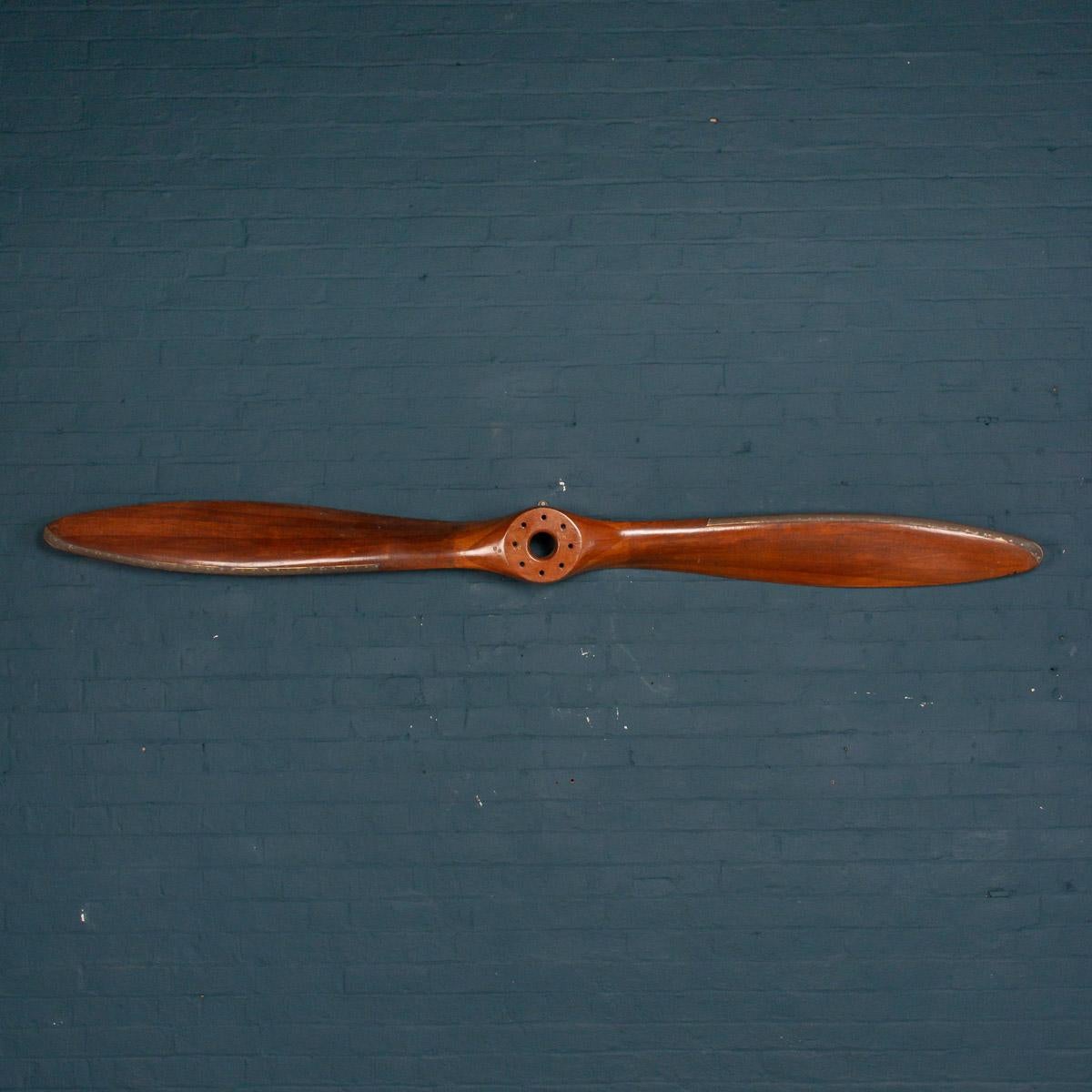 Antique 20th century Avro 504K laminated mahogany propeller bearing stamped date 11/25 (November 1925) and original manufacturer’s proof marks, having folded brass blade guards. The Avro 504 was a First World War biplane aircraft made by the Avro