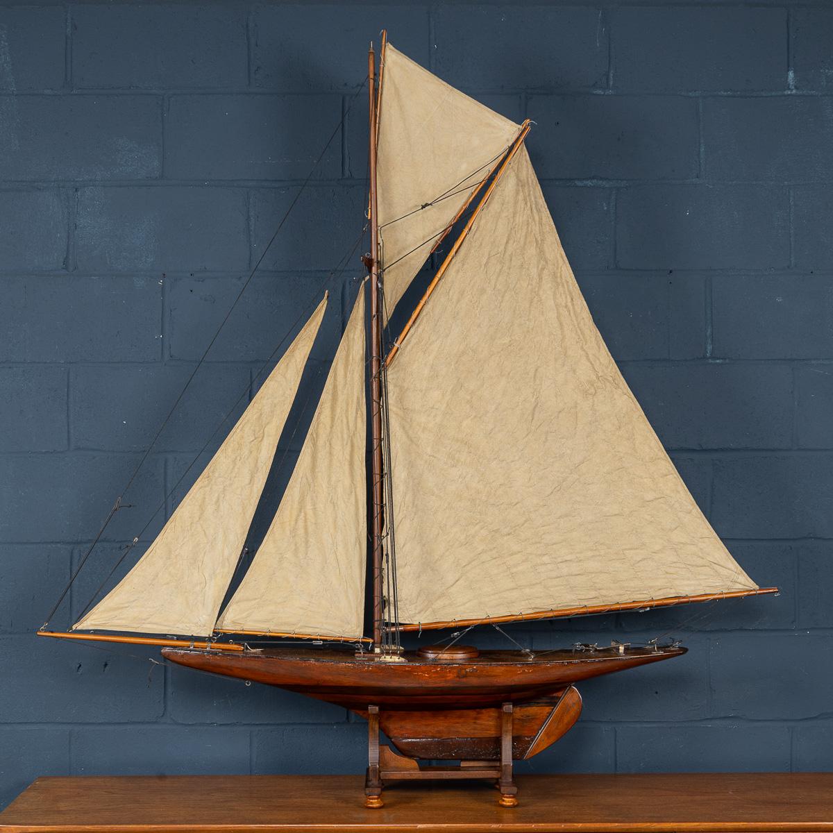 Un magnifico yacht d'epoca con gaff rigged e cutter pond, risalente agli anni '20, splendidamente realizzato in legno intagliato con una sorprendente costruzione bicolore. Questo elegante modello di yacht presenta un tradizionale armo gaff cutter e