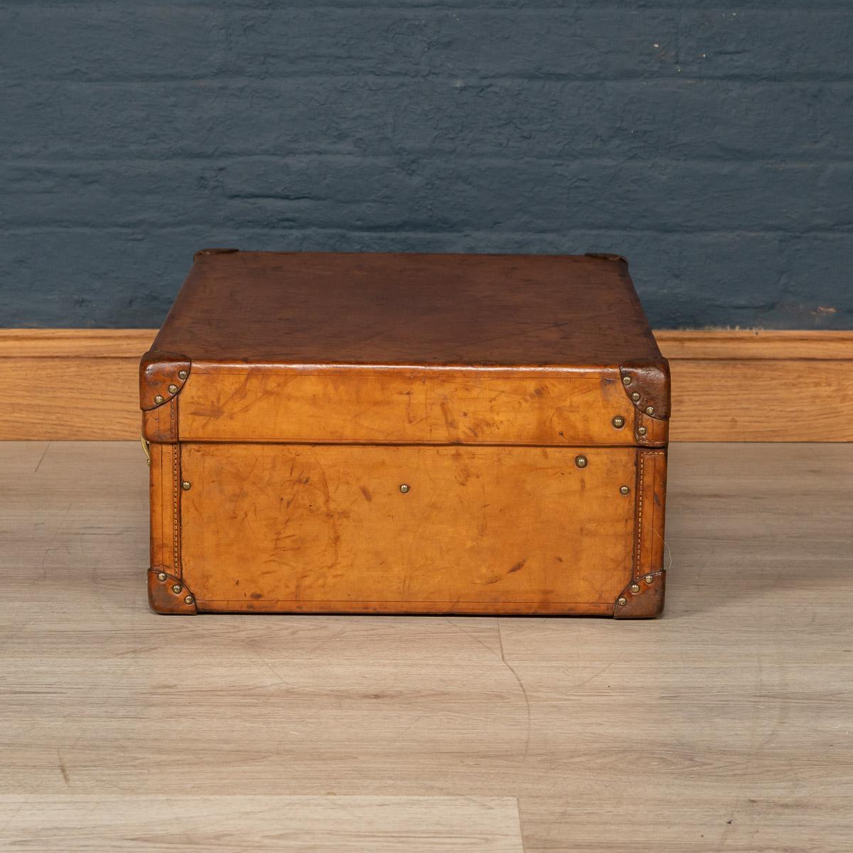 Antique early 20th century very rare Louis Vuitton suitcase, covered not in the world famous (but more common) monogram canvas but in a single piece of cow hide. These all-leather trunks and cases were made by special order and Louis Vuitton used to