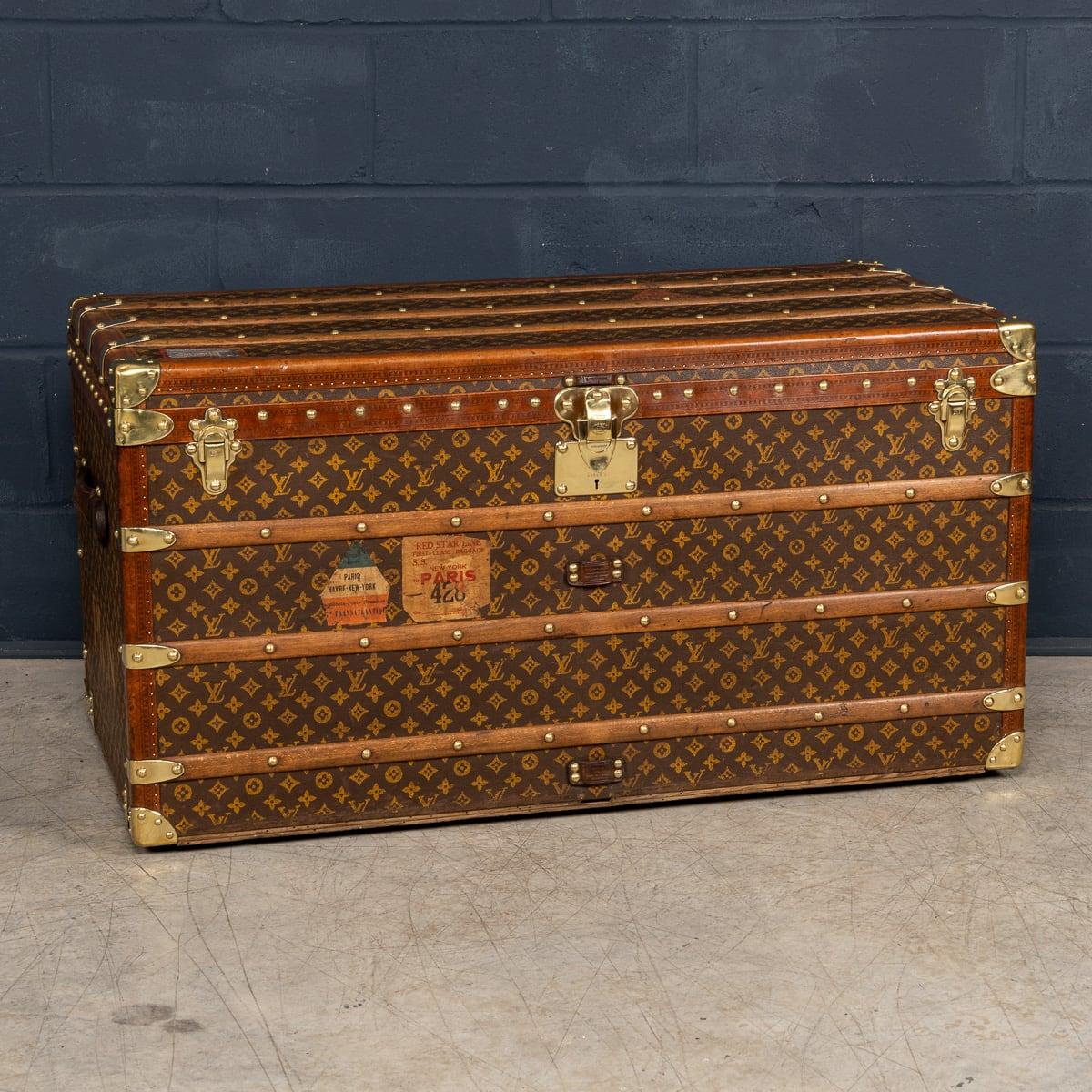 An exquisite Louis Vuitton trunk from the early part of the 20th century. An absolutely essential item for elite travellers of its time the trunk is adorned in the iconic LV monogrammed canvas, accented by lozine trim and brass fittings. This trunk