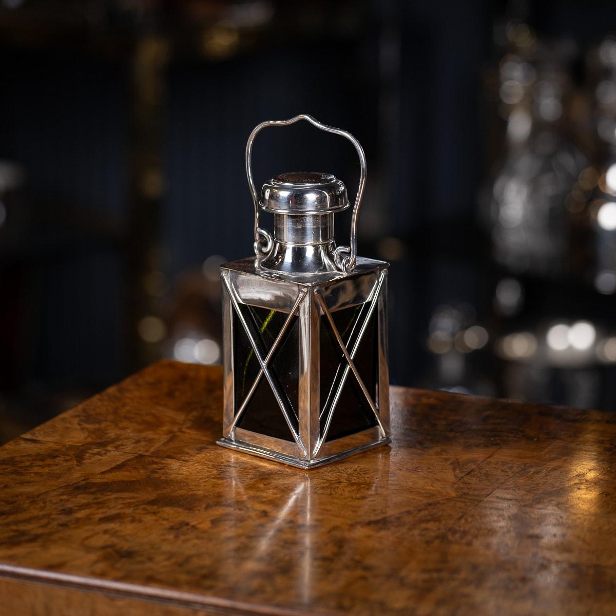 Antique early 20th-century Edwardian silver plate and green glass decanter is crafted in the shape of a lantern by Marples & Co. This unique lantern decanter features an engraving on the top that reads 