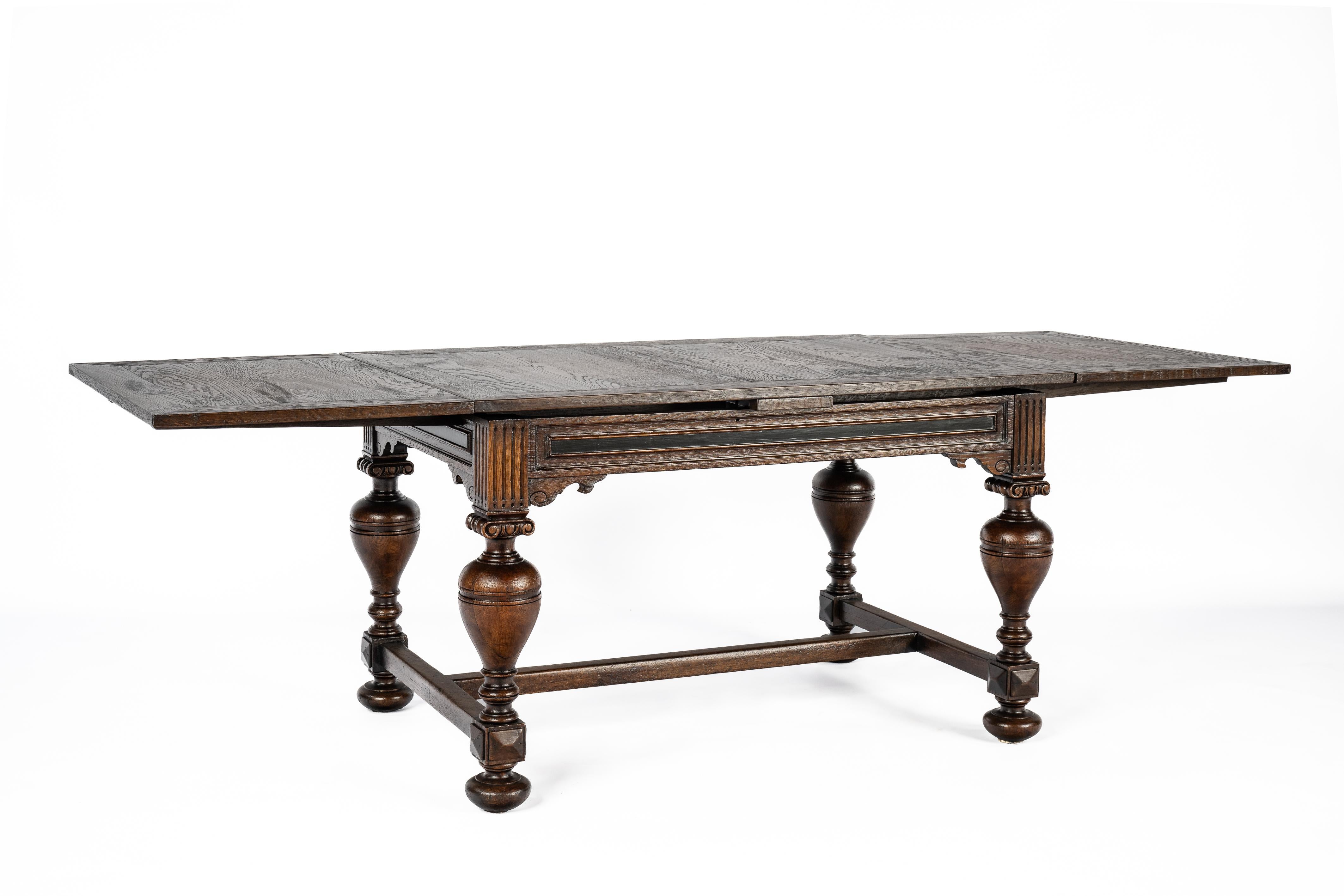 On offer here is a stunning table meticulously crafted from the finest European summer oak in the Netherlands around 1900. This exquisite piece embodies the defining traits of a typical Hollandic Renaissance table, featuring legs adorned with