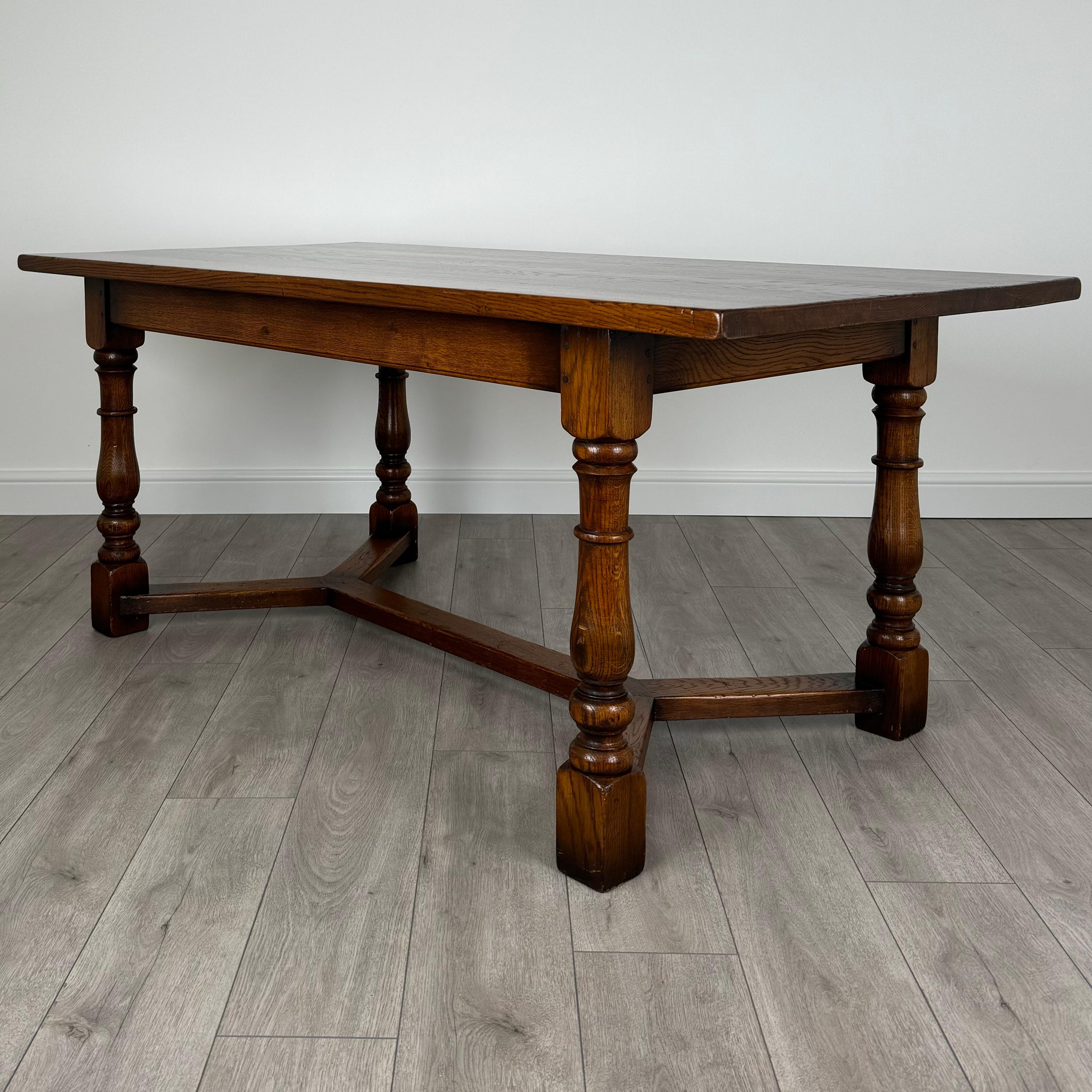 Améliorez votre espace repas avec cette superbe table de salle à manger en chêne du XXe siècle, de style réfractaire classique. Cette pièce exquise présente un magnifique grain de chêne naturel et des couleurs riches, ajoutant un caractère
