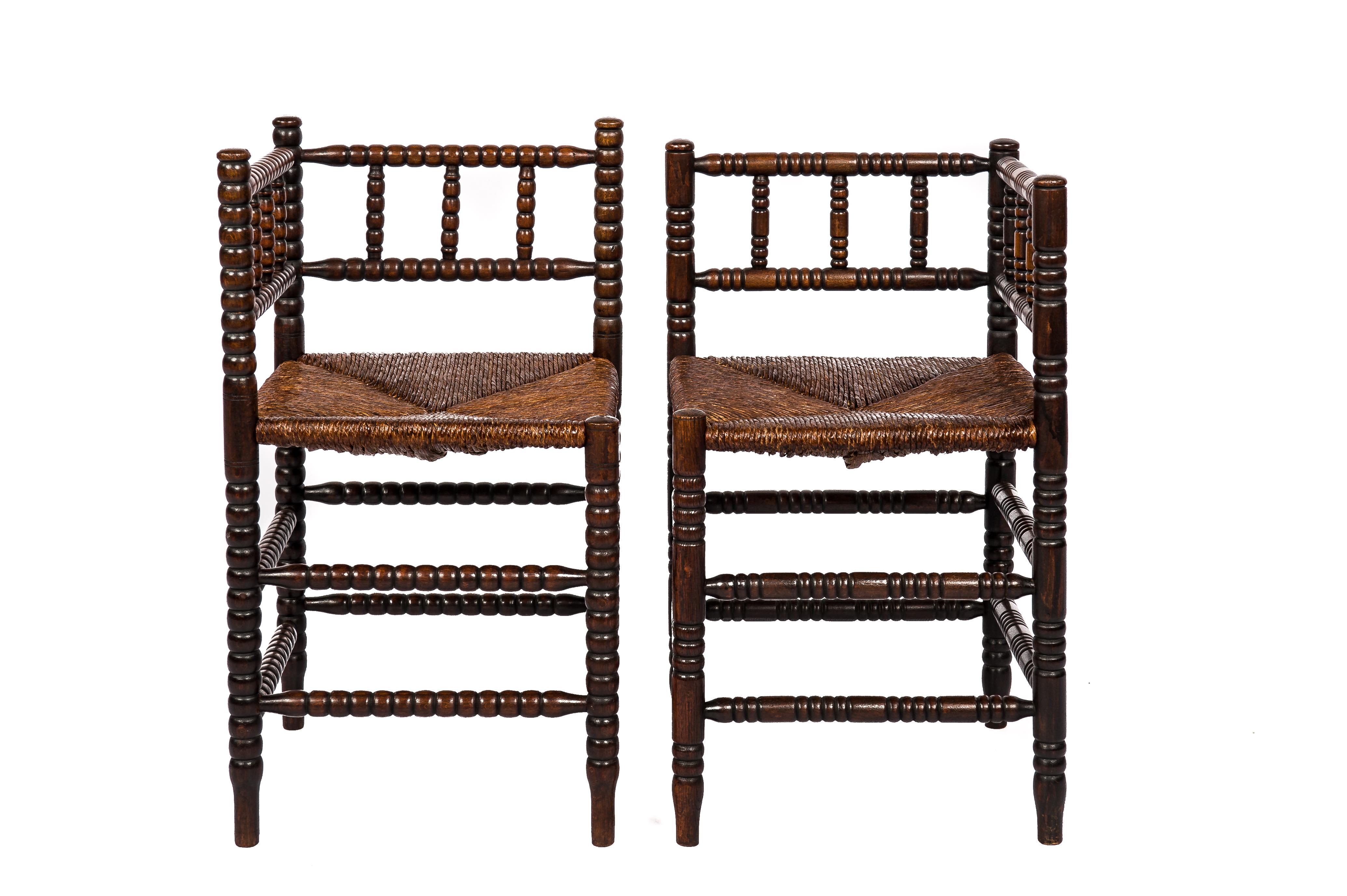 Discover a set of antique Bobbin chairs that captures the essence of mid-19th century France. These corner chairs, each with its own unique character, offer a touch of timeless elegance. Featuring hand-woven rush seats adorned with a rich patina,