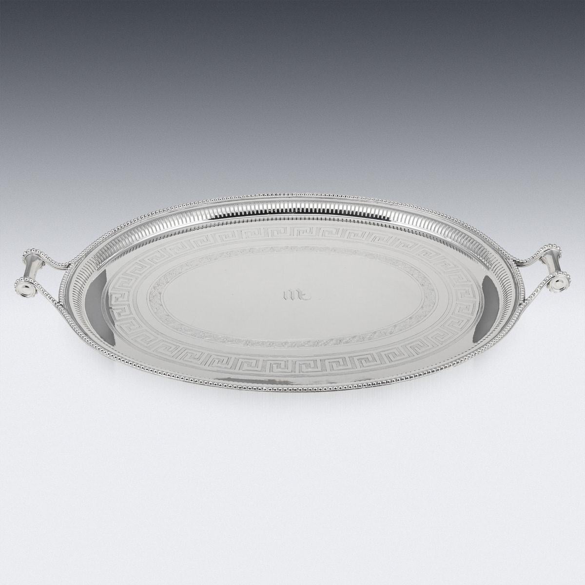 Antique early 20th Century silver plated large oval serving tray, featuring a Greek key border and intricately turned handles. Crafted by the renowned silversmiths James Dixon & Sons of Sheffield, it bears the serial number 199 and the initial M at