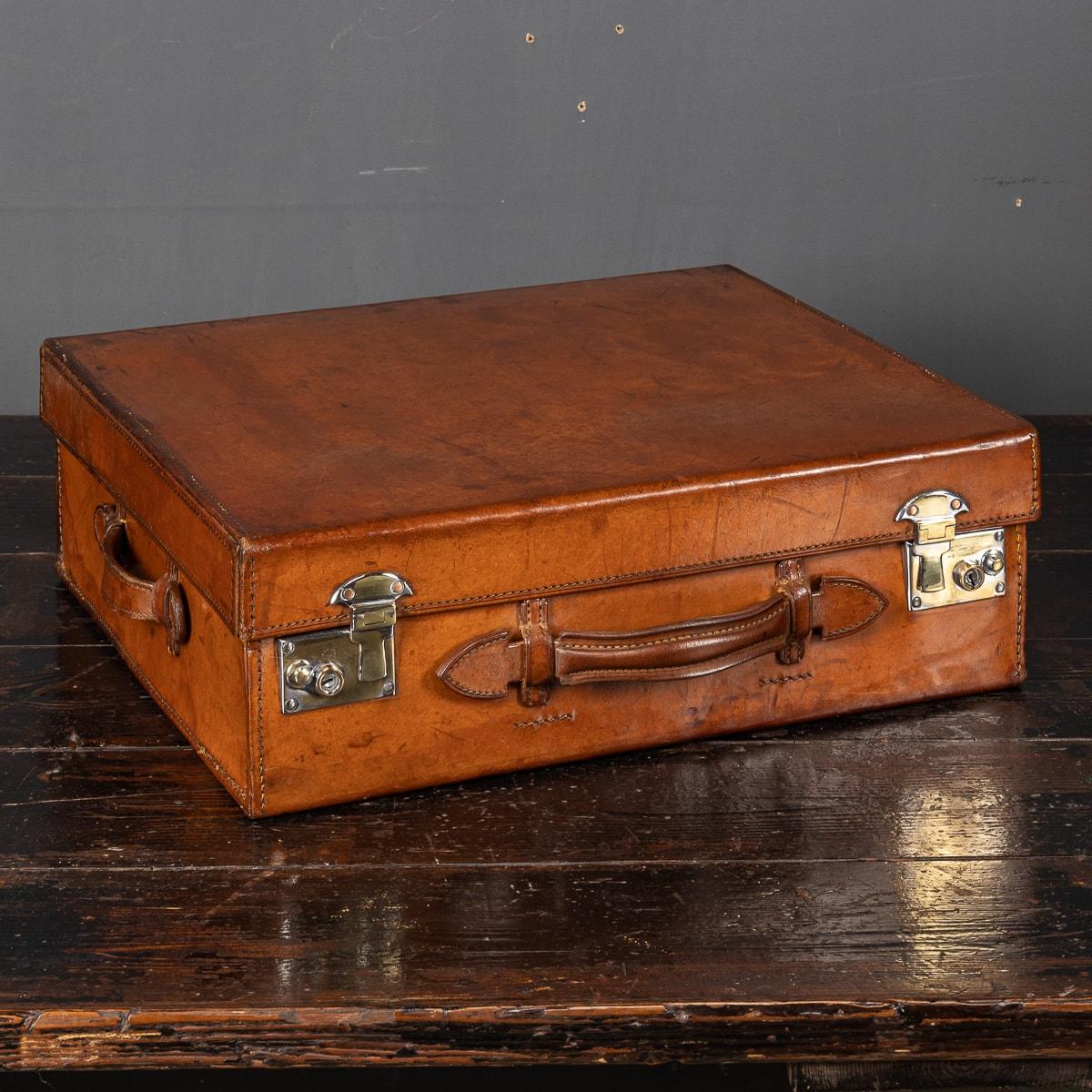 An antique early 20th Century hat trunk, lined with the original moire silk in a champagne colour with straps to keep hats in place. This trunk comes with original polished metal locks and leather handles.

Antique bridle hat trunks, reminiscent of