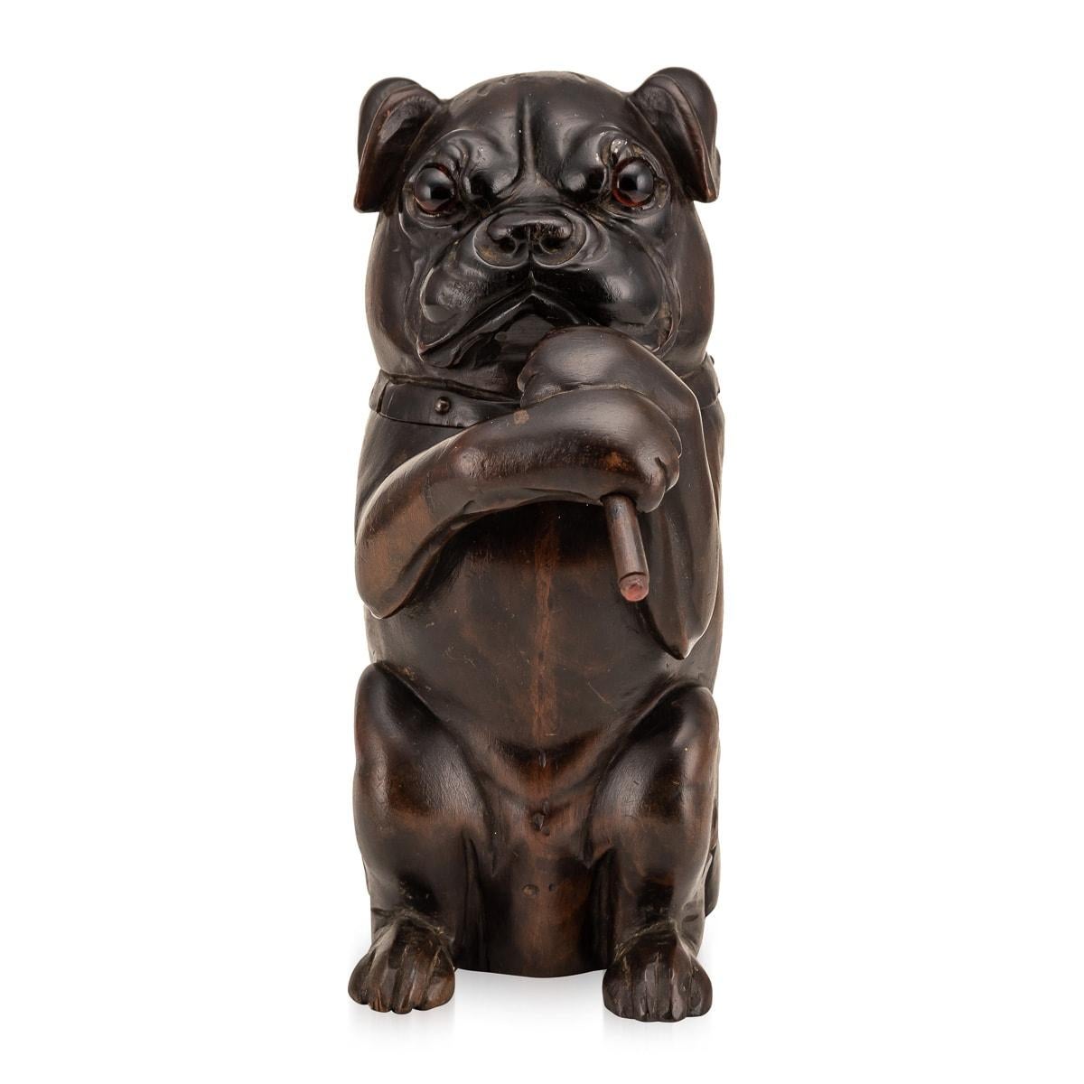 Antique early-20th Century Victorian lignum vitae bulldog tobacco jar featuring a carved bulldog sat on it's heind legs smoking. The entire head lifts to reveal a metal liner in which tobacco was originally stored. A truly wonderful piece and a must