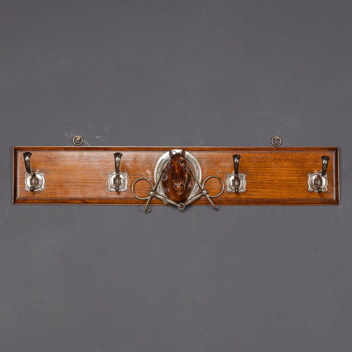 Antique 19th Century Victorian oak coat rack, adorned with a finely carved horse's head. Mounted on an oak plinth, it features four sleek white metal hooks, with the focal point being the intricately carved horse head detail. This charming and