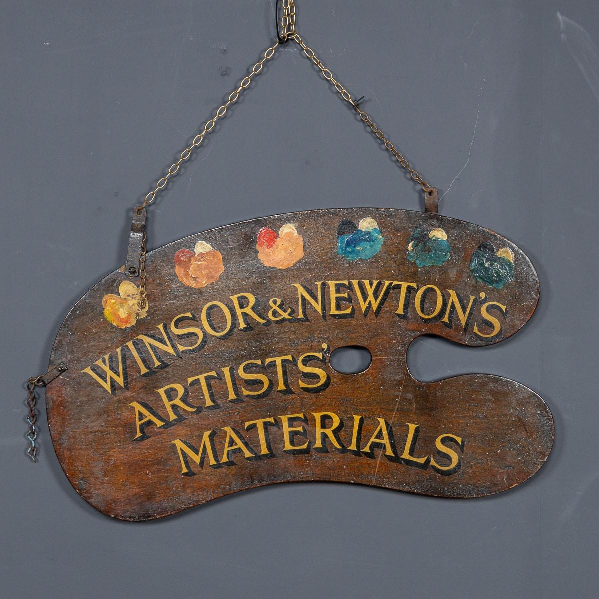 Antique early-20th Century advertising sign for the art suppliers Winsor & Newton. Designed in the shape of an artists paint palette with a selection of coloured paints and golden text 
