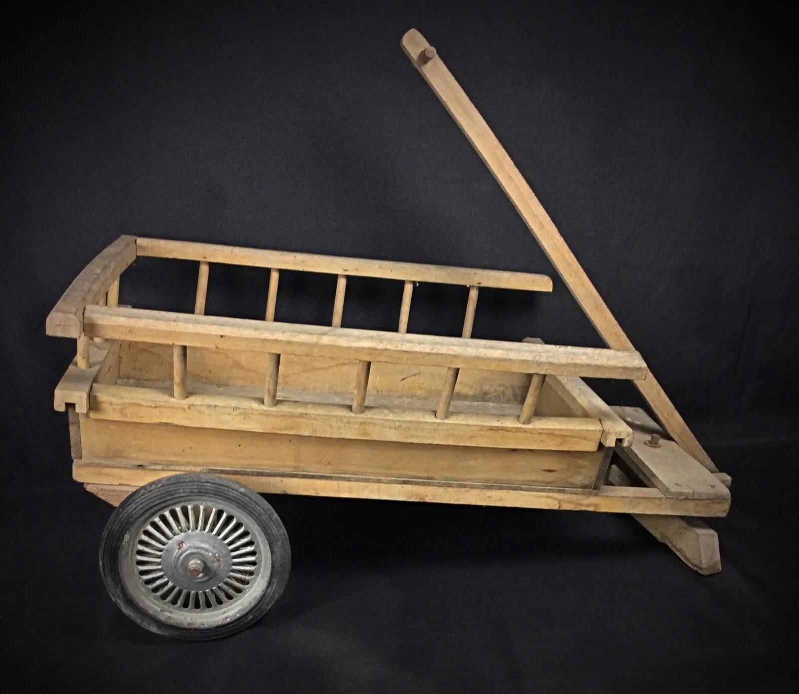 This antique wooden two-wheeled cart from the 20th century is in good condition for its age. The cart will be shipped disassembled, but it is easy to reassemble. The wood shows signs of wear and would benefit from refinishing, and all metal parts