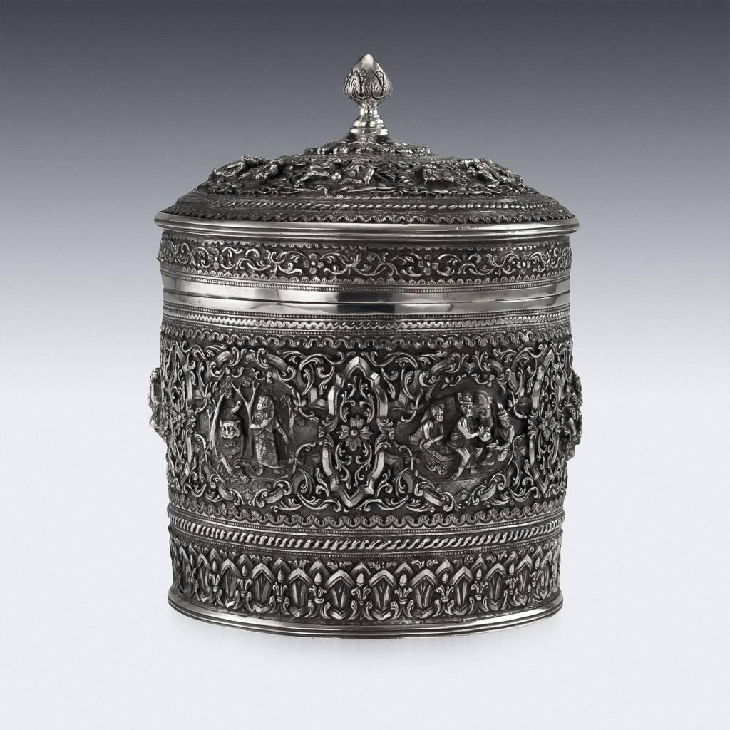 Antique early-20th century Burmese solid silver betel box, highly-decorative, repousse' decorated in high relief depicting different traditional scenes from the Burmese mythology, showing very detailed figures set against a chiselled matted