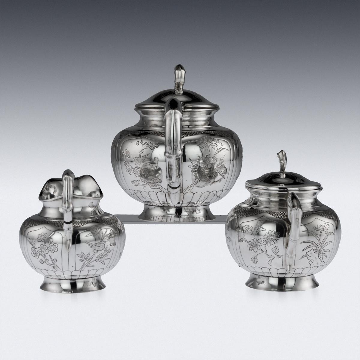 Antique early-20th Century rare Chinese solid silver impressive tea service on tray, comprising of a teapot, covered sugar bowl, milk jug and tray, each body is hand engraved with exotic birds within stylised cartooches, the hollow handles and spout