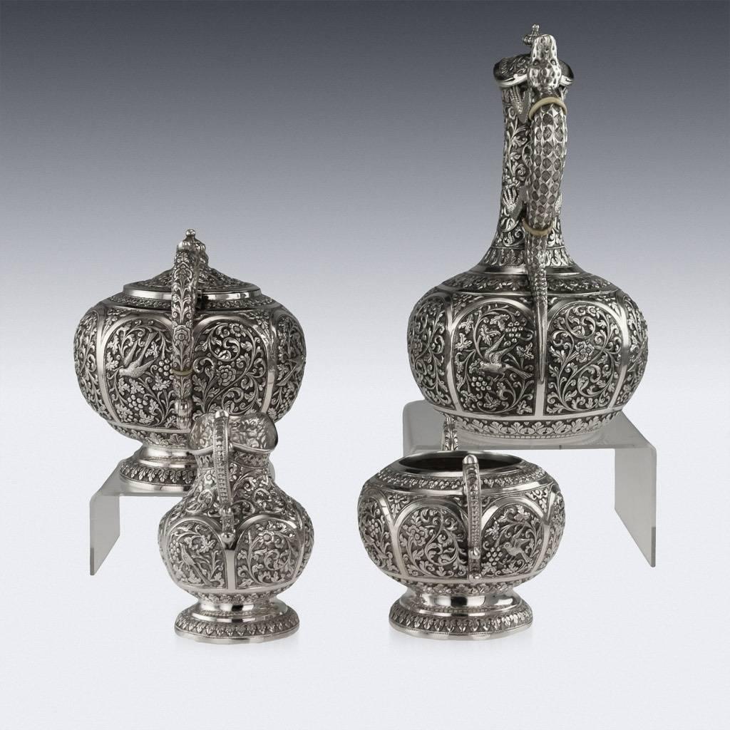 Antique early-20th century exceptional Indian Karachi-Cutch solid silver repousse four piece tea set, comprising of a water jug, teapot, sugar bowl and cream jug, each piece is profusely and beautifully repousse' decorated with scrolling foliage,