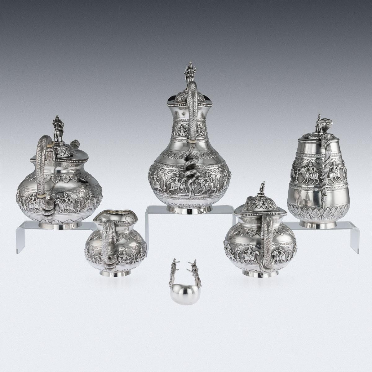 Antique early-20th Century Exceptional Indian colonial solid silver six-piece tea service, comprising of coffee pot, water jug, teapot, sugar bowl, cream jug, sugar tongs and a tray, each body is profusely and beautifully repousse' decorated with