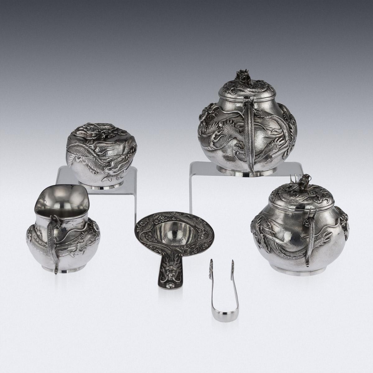 Antique early 20th century Japanese Meiji period, solid silver six-piece tea and coffee set on tray, exceptional and magnificent quality, chased, embossed and applied with a water dragon in very high relief, with dragon-form handles and spouts