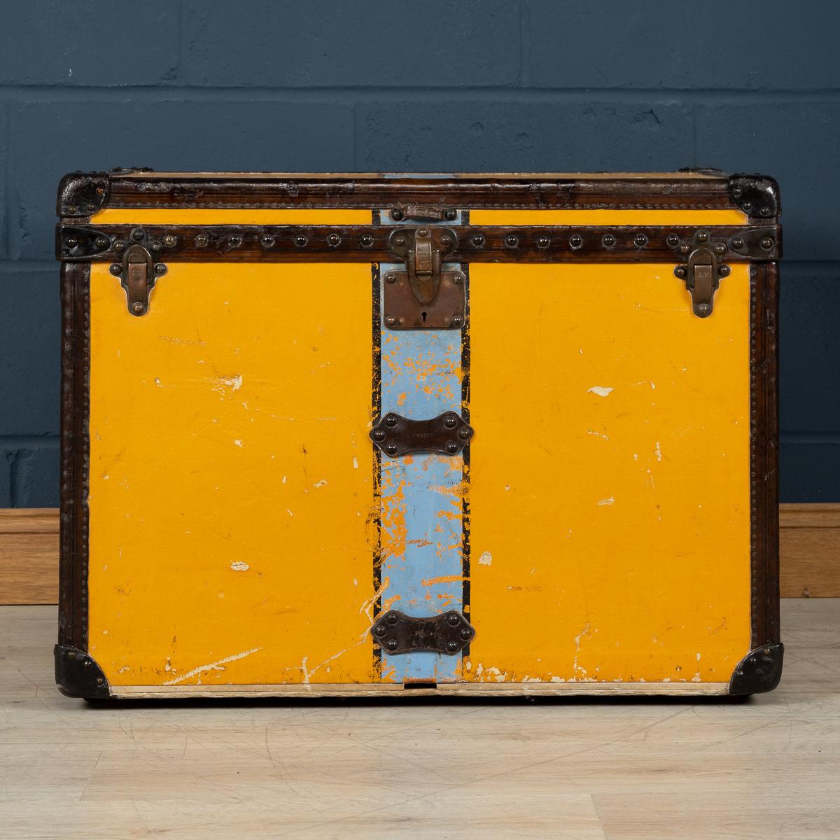 A very rare wardrobe trunk by Louis Vuitton dating to the early part of the 20th century (circa 1900-1910). Covered in the famous orange “Vuittonite“ canvas, this horizontal courier trunk is much rarer than its monogrammed brothers with its stain