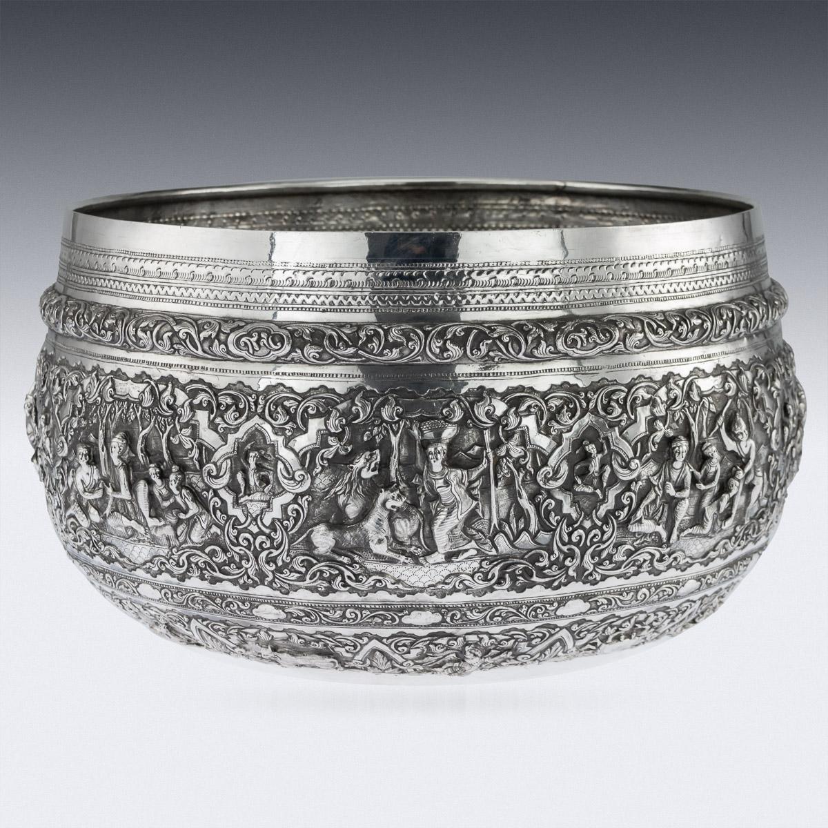 Antique early-20th century monumental Burmese, (Myanmar) solid silver Thabeik bowl, repousse' decorated in high relief with detailed panels depicting different traditional scenes from the Burmese mythology, showing very detailed figures set against