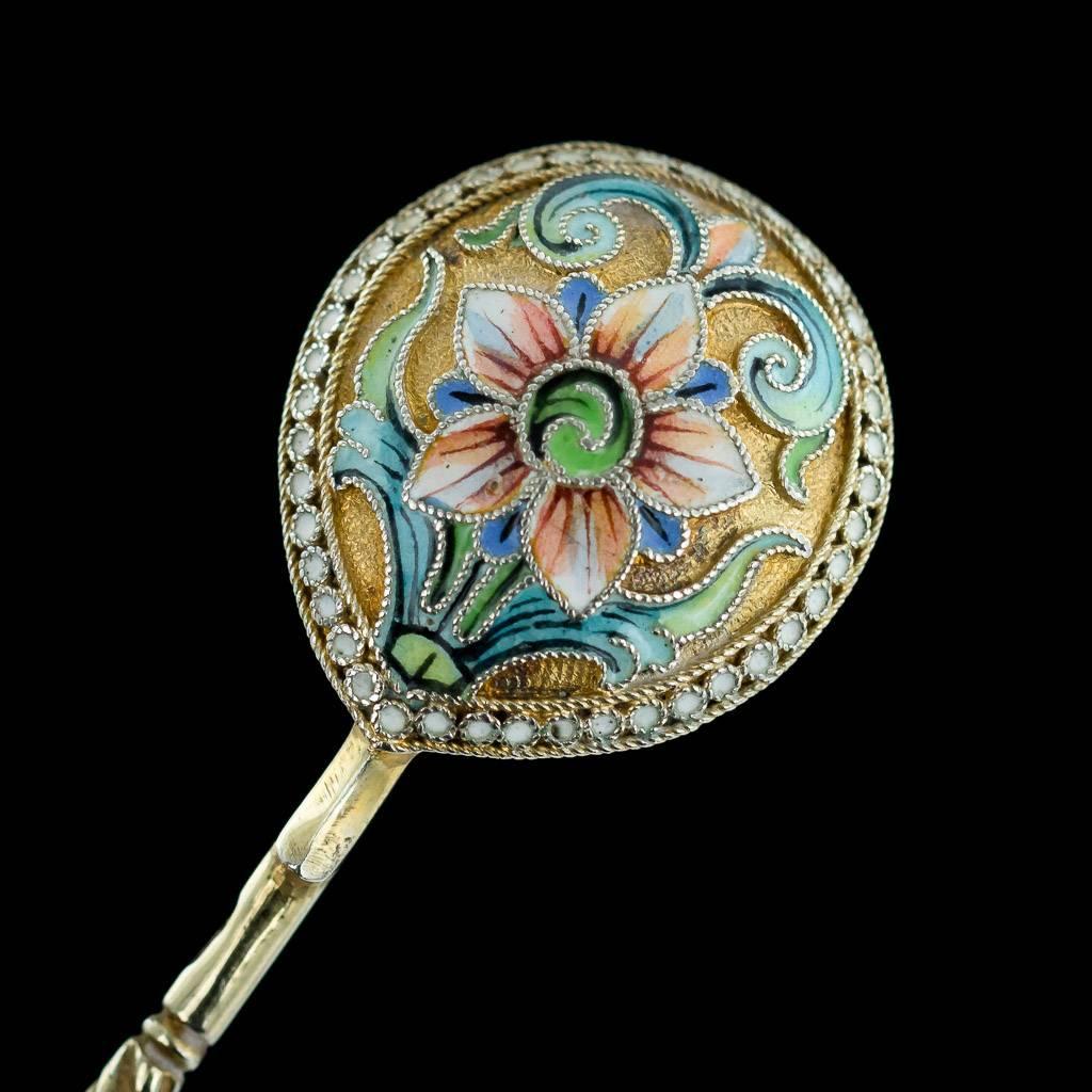 Antique 20th century Imperial Russian solid silver and cloisonné' enamel set of 12 spoons, the round bowl is applied on reverse with multicolored shaded polychrome enamel scrolls, with white beaded boarder on matted silver gilt ground. The twist
