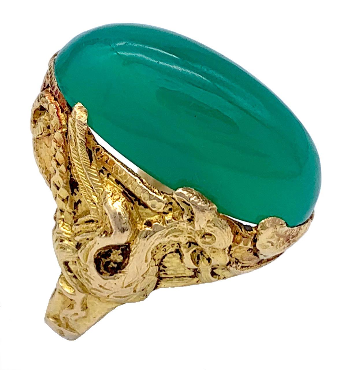 This impressive chrysophrase cabochon ring is mounted in a beautiful shank decorated with dragons crafted out of 21 karat gold. 