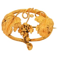 Broche ancienne en forme de vigne en or jaune 21 carats