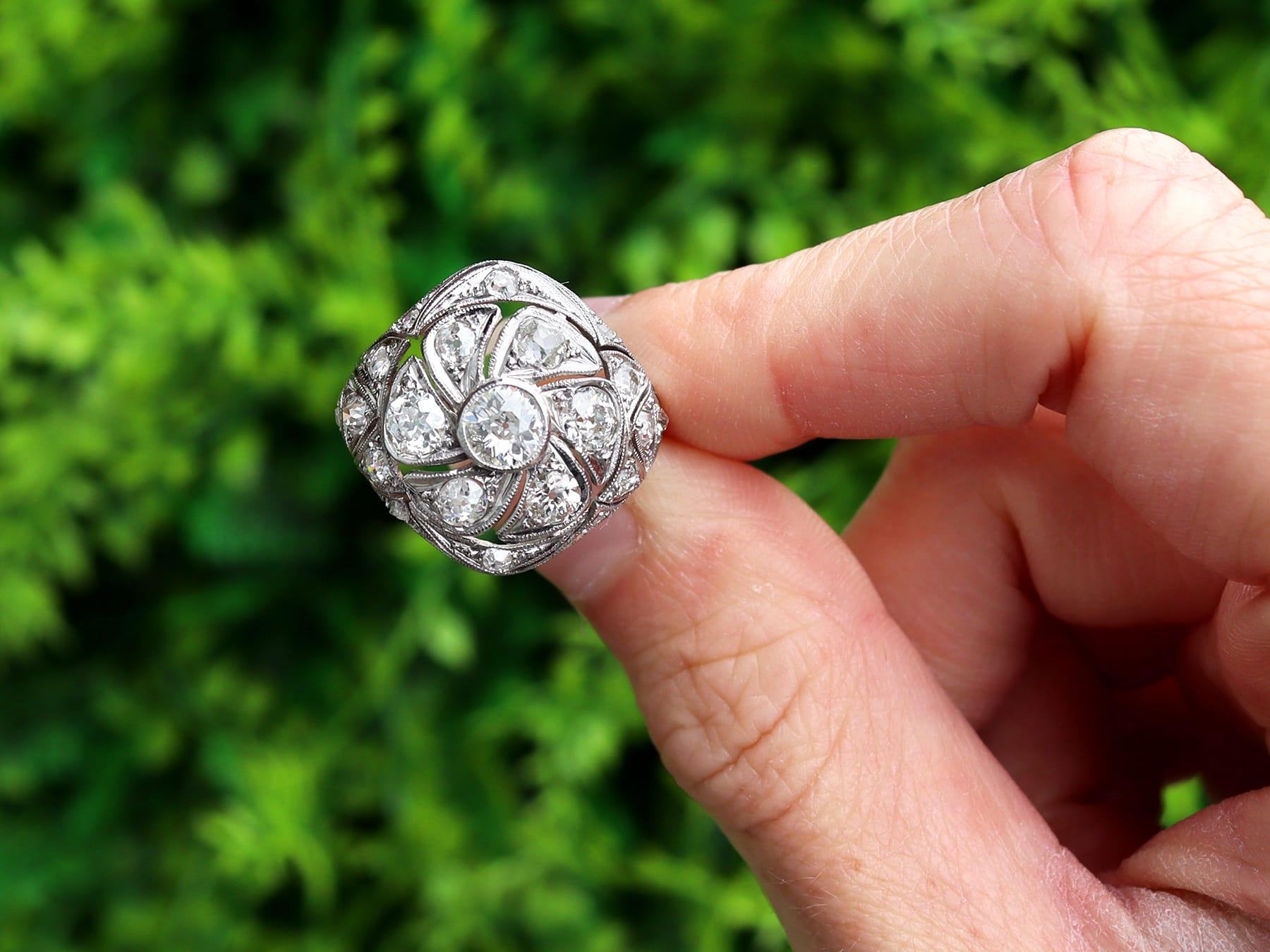 A stunning, fine and impressive antique 2.19 carat diamond and platinum cocktail ring; part of our antique Art Deco jewellery collections.

This stunning, fine and impressive antique diamond ring has been crafted in platinum.

The pierced decorated,