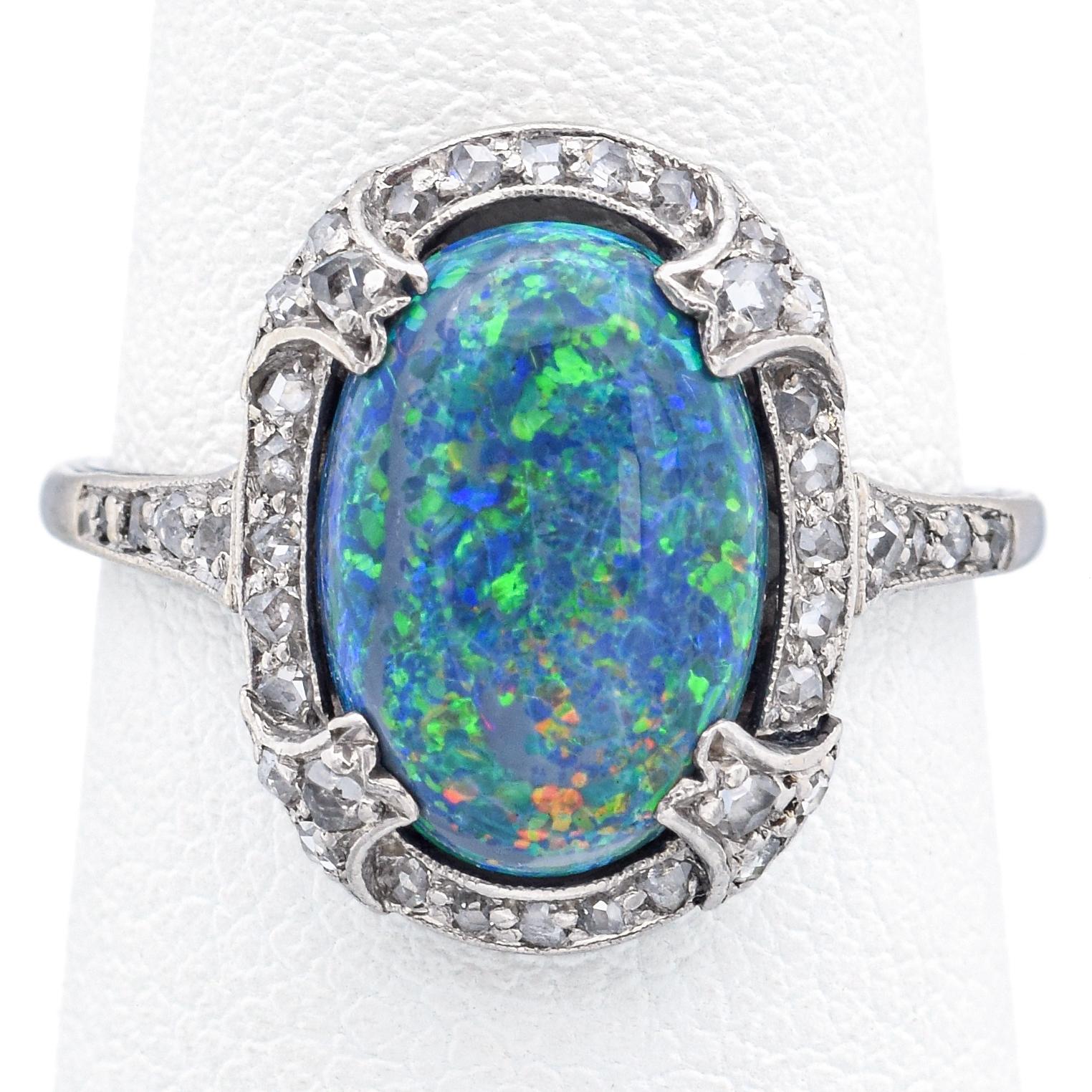Weight: 3.2 Grams
Stone: 2.19 Ct (12x8x4 mm) Black Opal & Approx 0.23 TCW (0.005-0.01 ct) Rose Cut Diamonds
Face of Ring: 16 x 15 x 5 mm
Ring Size: 5.5
Hallmark:  Platinum Tested

Item #: BR-1077-101823-17