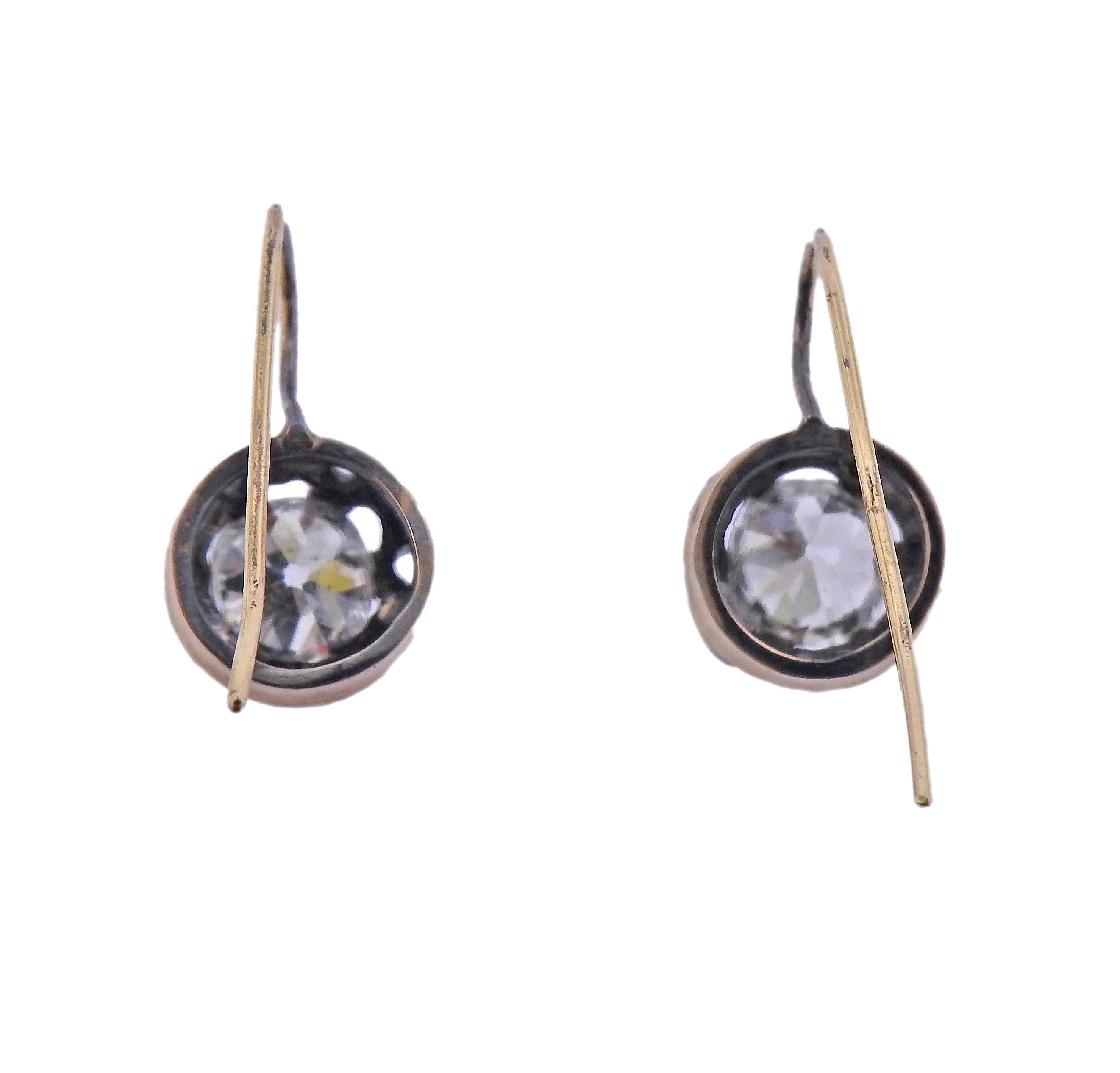 Pair of antique 14k gold and silver earrings, with two old mine cut diamonds - approx. 2.20ctw total. Earrings are 17mm x 10mm. Weight -3.4 grams. 