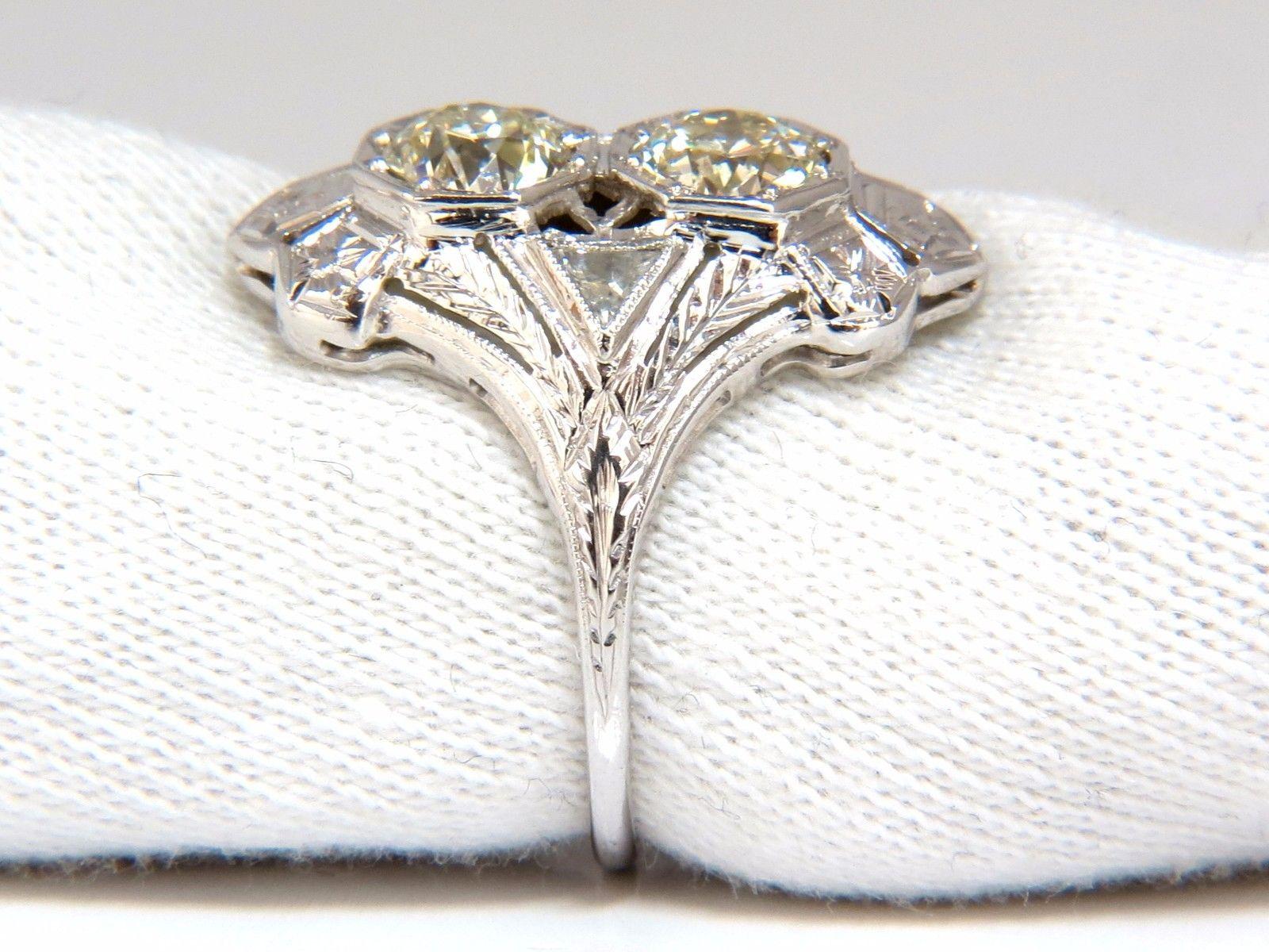 Victorian Twin Diamond Ring.

2.00ct. Natural round diamonds (2) Old Mine Cuts.

K color VS-1 clarity

Each diamond: 6mm diameter 

Side trilliant diamonds: 

 .20ct 

I-color si-2 clarity.

18kt. white gold

Ring size: 8.5

Please inquire about