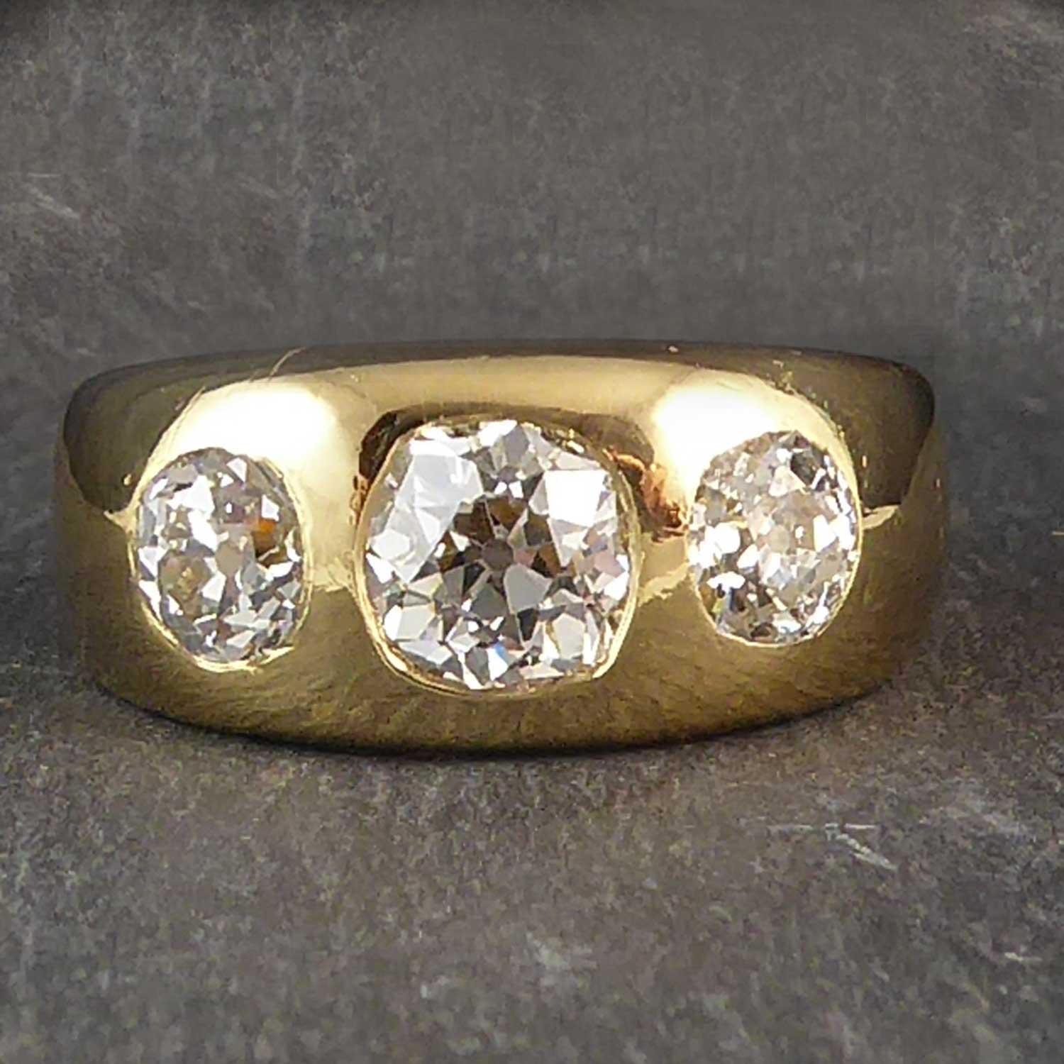A Victorian diamond three stone ring in a substantial 18ct yellow gold wide band that look fabulous worn as 