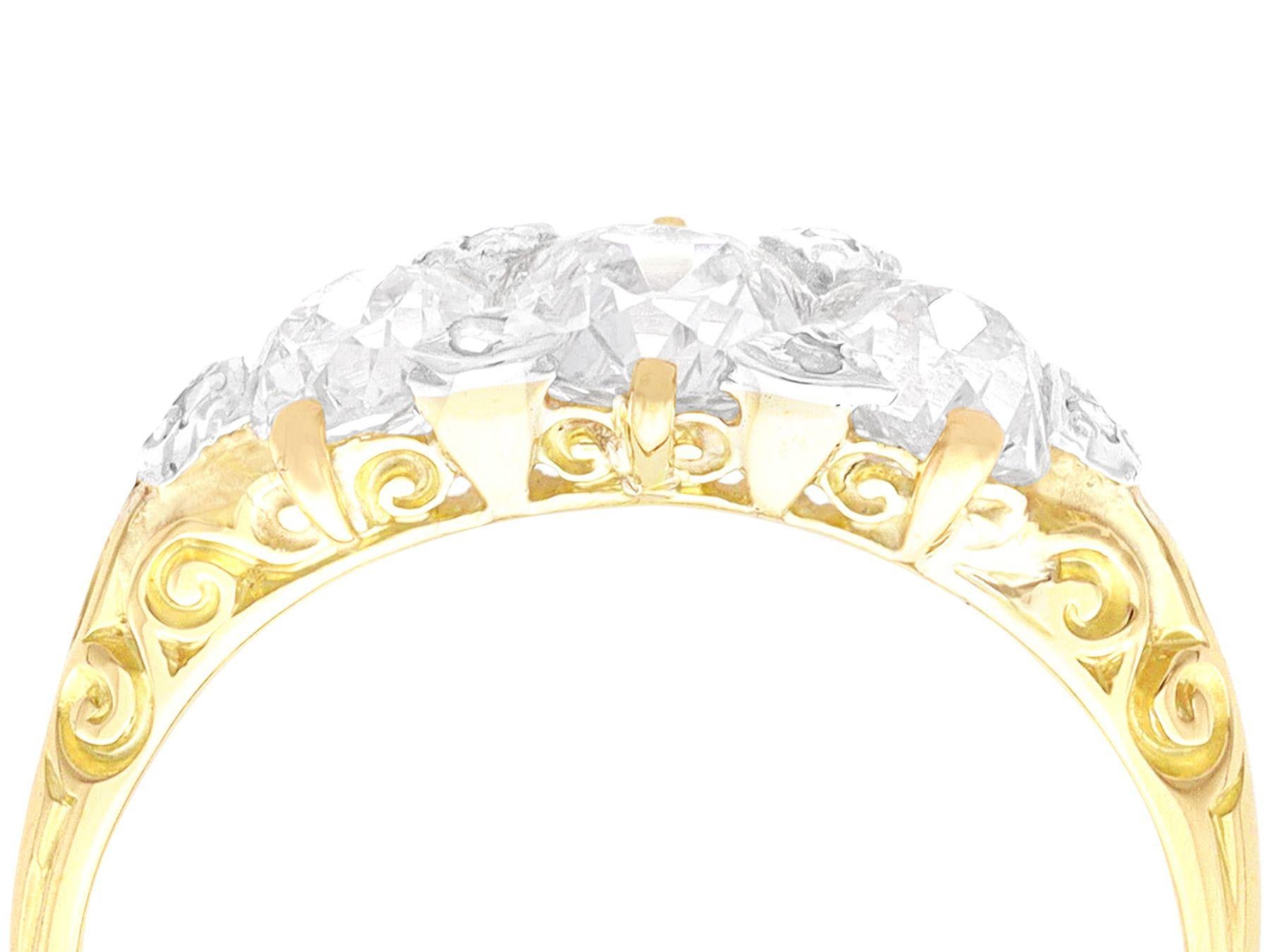 A stunning, fine and impressive antique 2.23 carat diamond, 18 karat yellow gold and silver set three stone ring; part of our diverse vintage diamond jewellery collections.

This stunning and impressive diamond trilogy ring has been crafted in 18k