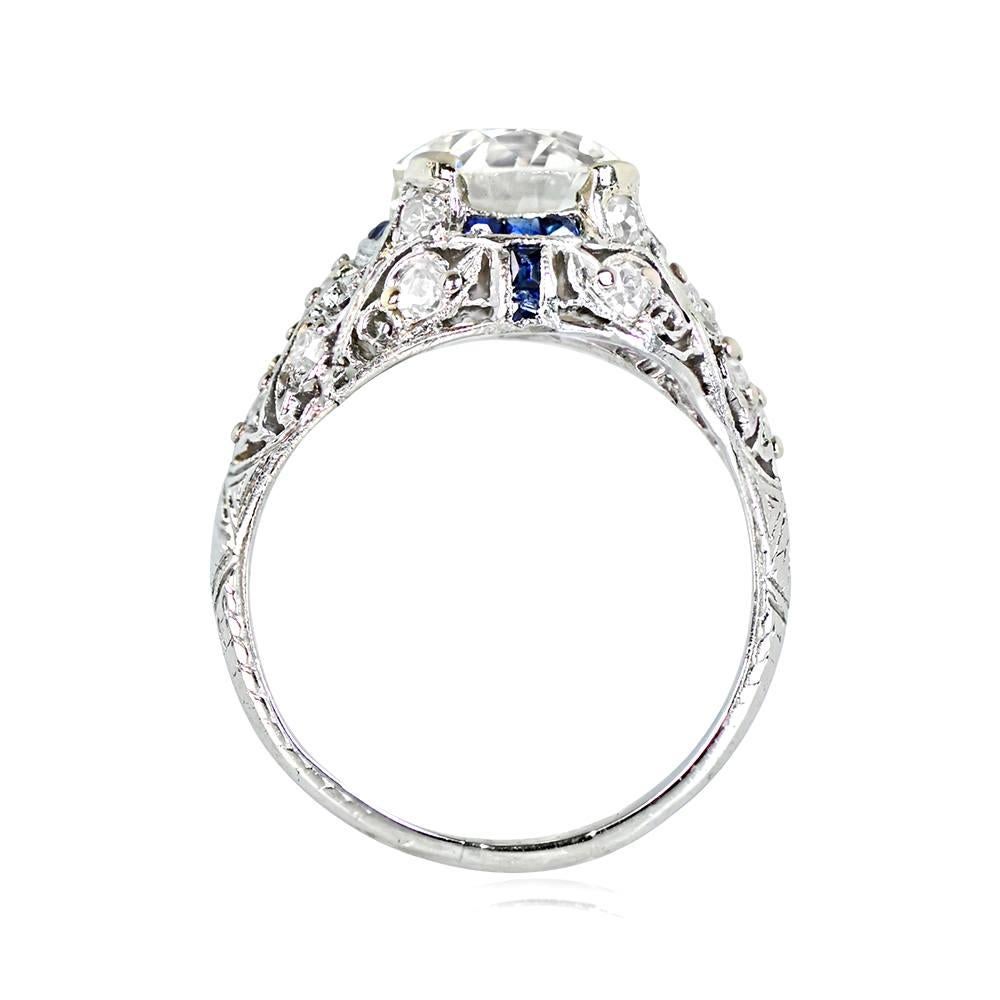 Art Deco engagement ring with a 2.24-carat old European cut diamond, K color, and VS2 clarity at the center. The diamond has a halo of French-cut natural sapphires, and the platinum mounting has handcrafted floral open-work filigree with diamond