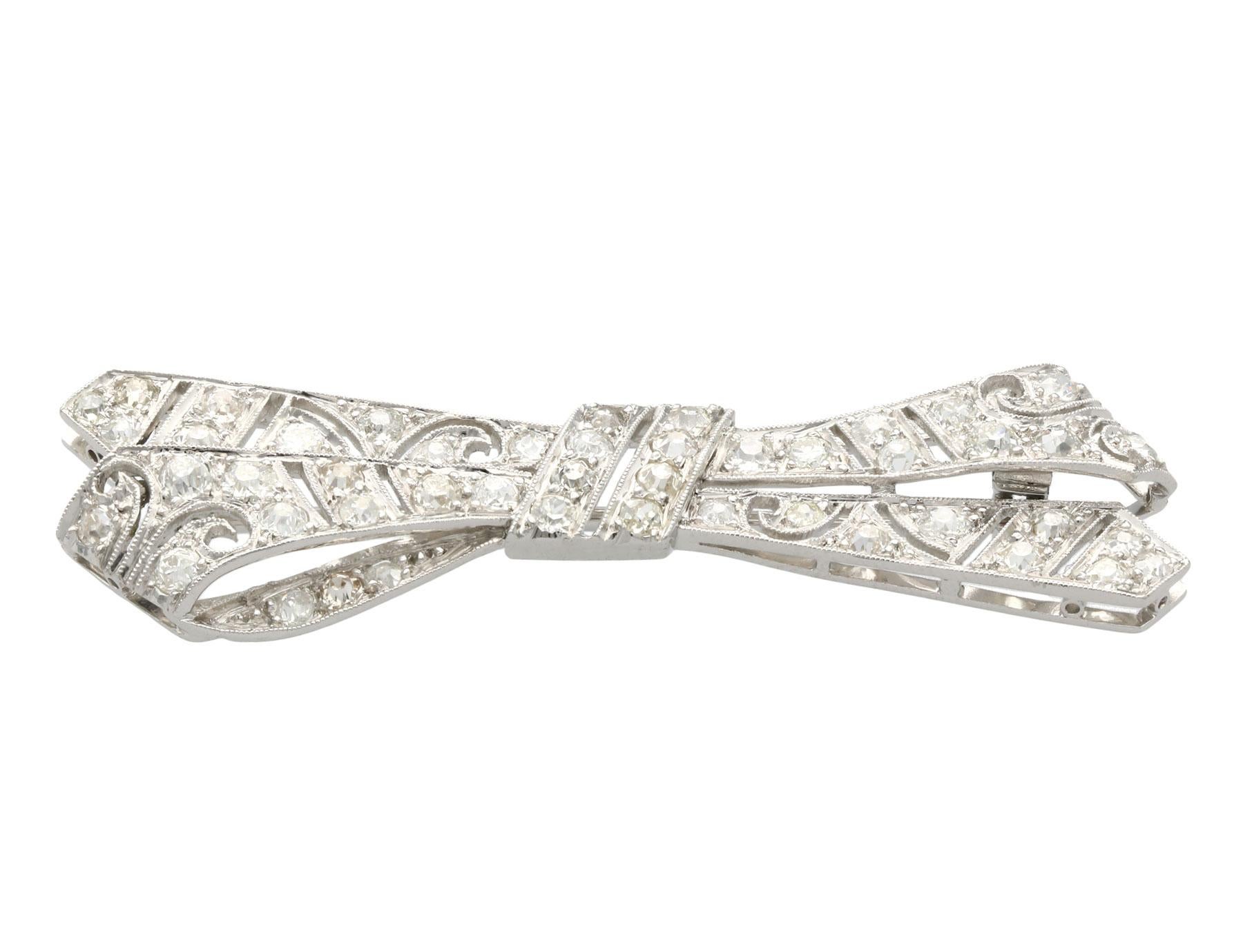 A stunning, fine, and impressive antique 2.36 carat diamond and platinum brooch in the form of a bow; part of our antique jewellery and estate jewelry collections.

This stunning, fine, and impressive antique diamond brooch has been crafted in the