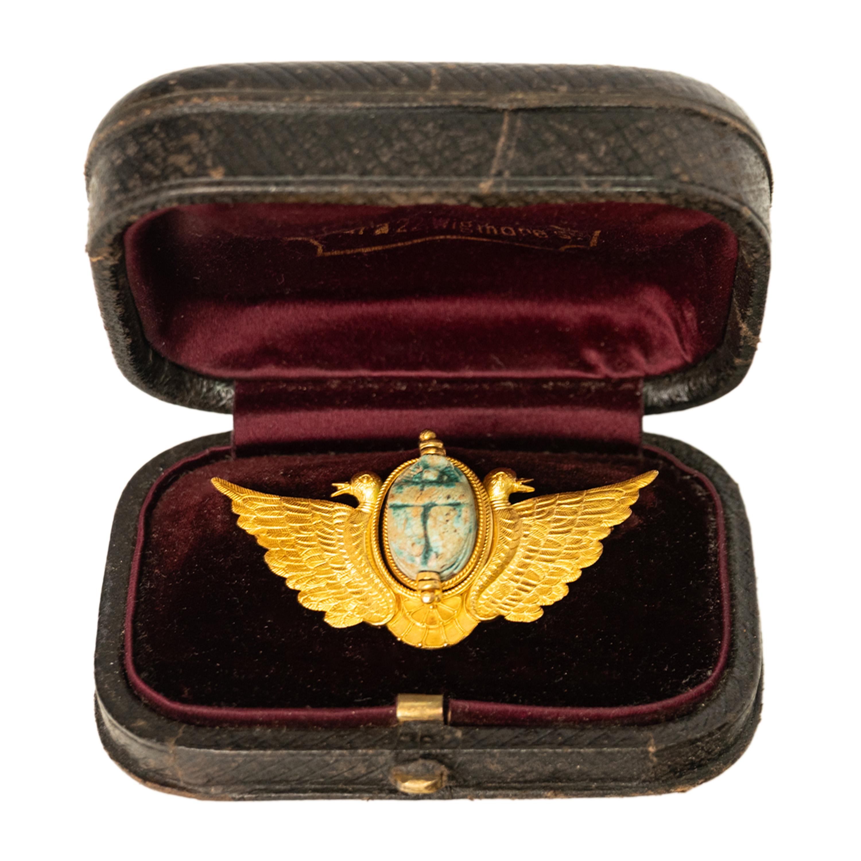 A wonderful antique 24 karat gold Egyptian Revival brooch set with an ancient 1500 B.C.E Egyptian faience pottery scarab, by the famous 19th century Italian jeweler Cesare Tombini, circa 1870.
A beautiful 24 Karat gold brooch decorated with twin