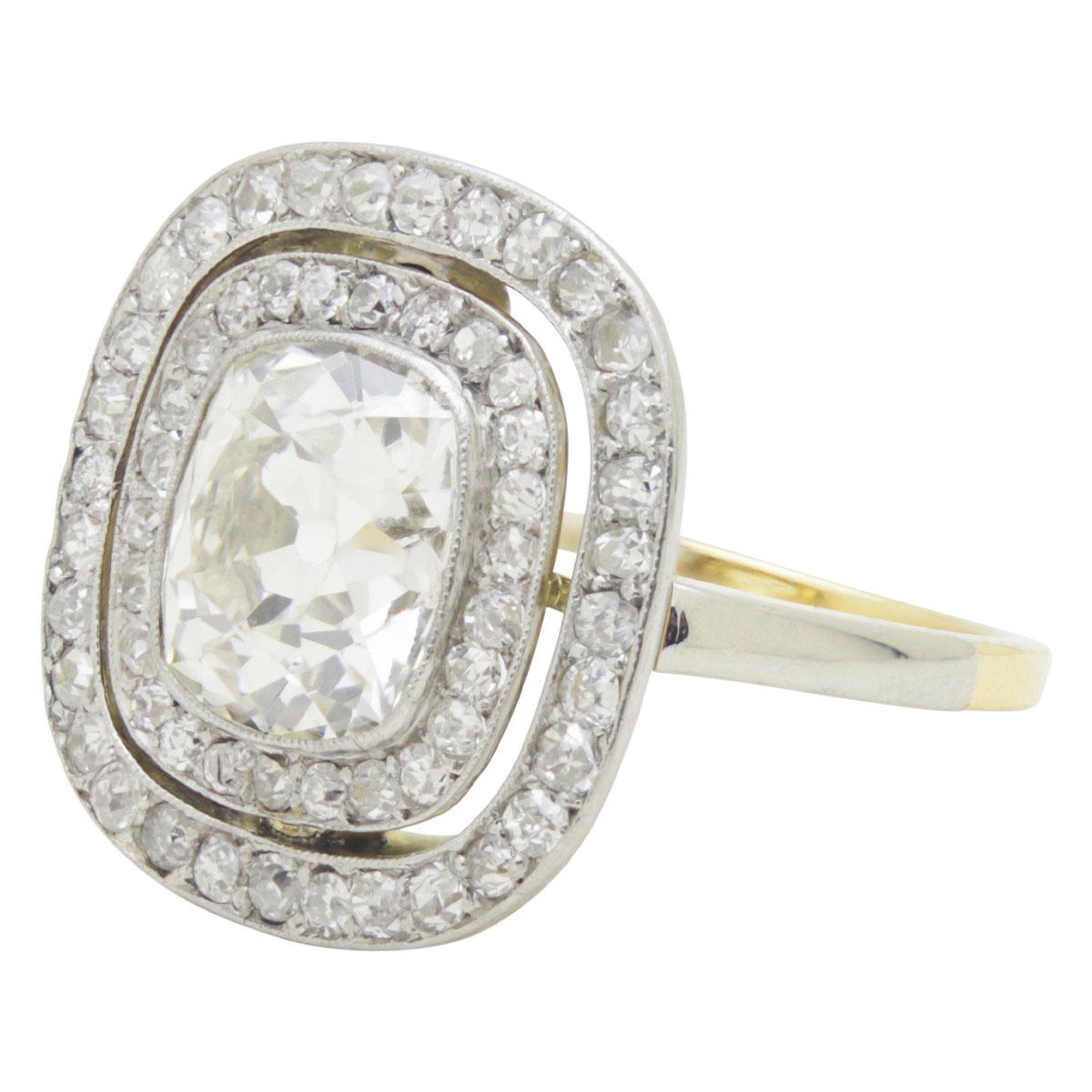 Spectacular is the only way to describe this antique old mine cushion cut diamond ring. Set with a central 2.45ct glittering antique old mine cushion cut diamond this stunning ring will NOT be missed on your hand. It has so much presence, if the
