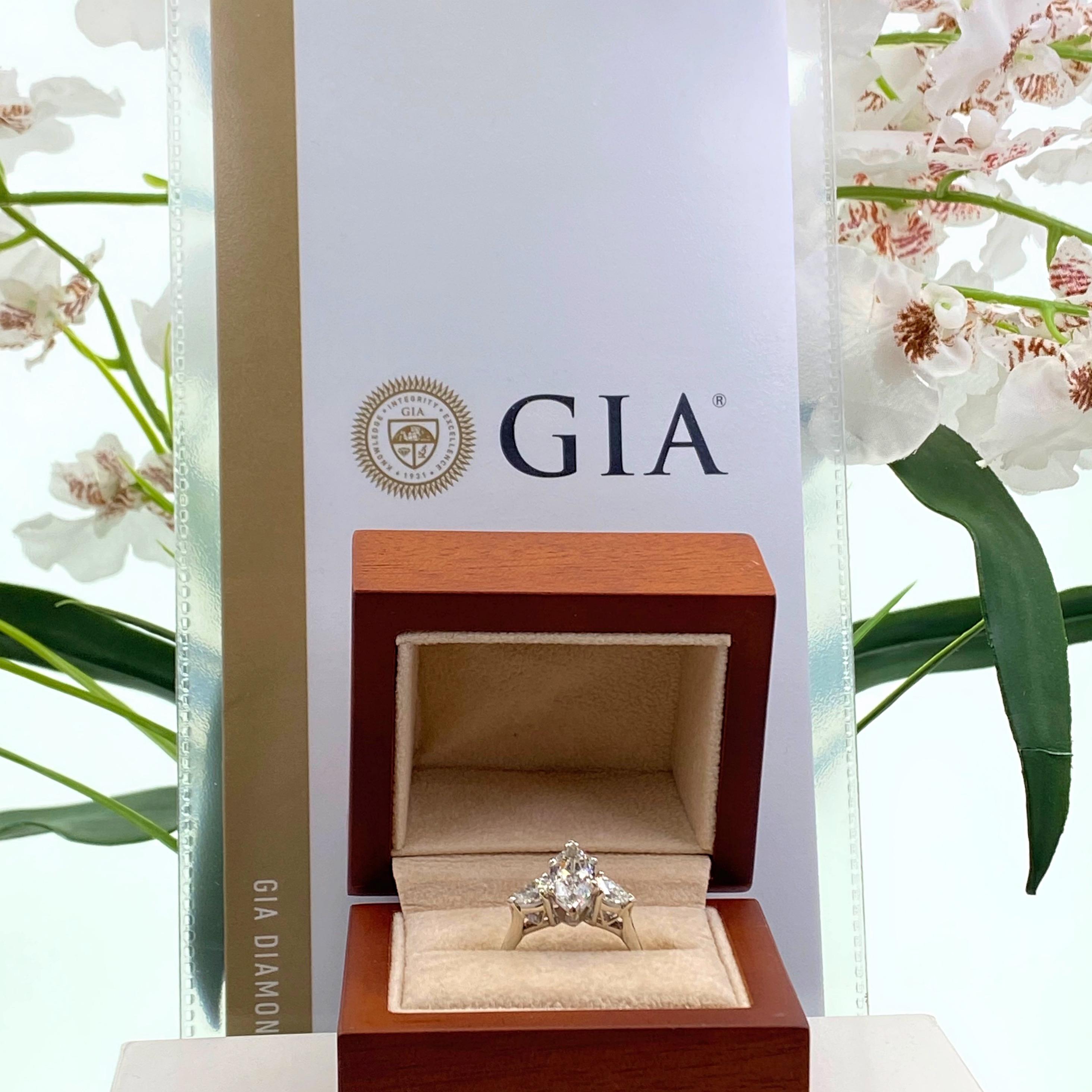 Antique Marquise Diamond Ring
Style: 3-Stone Engagement Ring
GIA Report number: 2211094578
Metal:  Platinum
Size / Measurements:  Ring Size 7, sizable
TCW:  2.56 Carats
Main Diamond: 1.96 Carat Antique Marquise Brilliant
Color & Clarity:  G color,